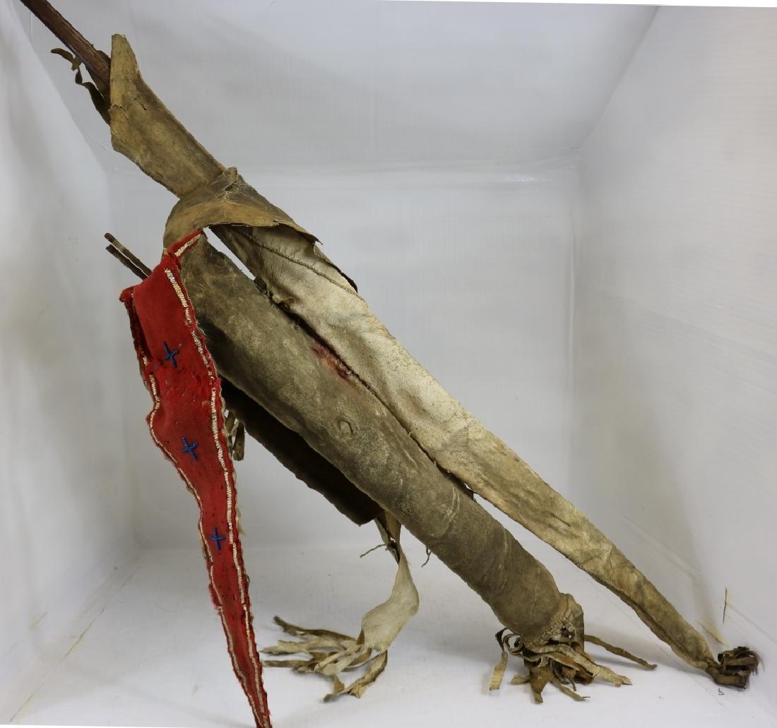 19TH C SOUTHERN PLAINS BOW CASE WITH BOW, QUIVER: CASE WITH 2 ARROWS MADE WITH TRADE CLOTH, QUILL DESIGN WITH BLUE BEADED CROSSES. LEATHER SHOWS STIFFNESS WITH CRACKING AND HOLES AND CLOTH SHOWS MOTH DAMAGE. 53" LONG.