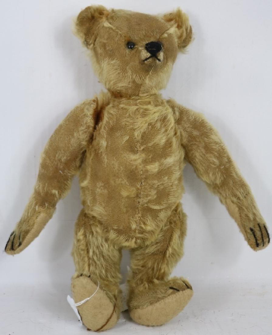 1907 STEIFF BEAR, 14" HIGH, JOINTED BODY, SHOWS: SOME LOSS TO MOHAIR. WEARING MODERN SWEATER. FROM THE COLLECTION OF THE LATE ALICE CHANNING.