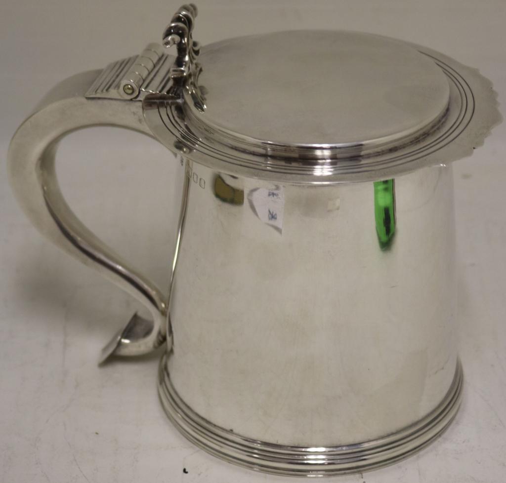 STERLING TANKARD BY RICHARD COMYNS, LONDON.: CREATED IN THE CHARLES III STYLE BEARING A TIFFANY LONDON STAMP. 25.36 OZT., 6" HIGH, 4 3/4" DEEP, 7 1/2" WIDE.
