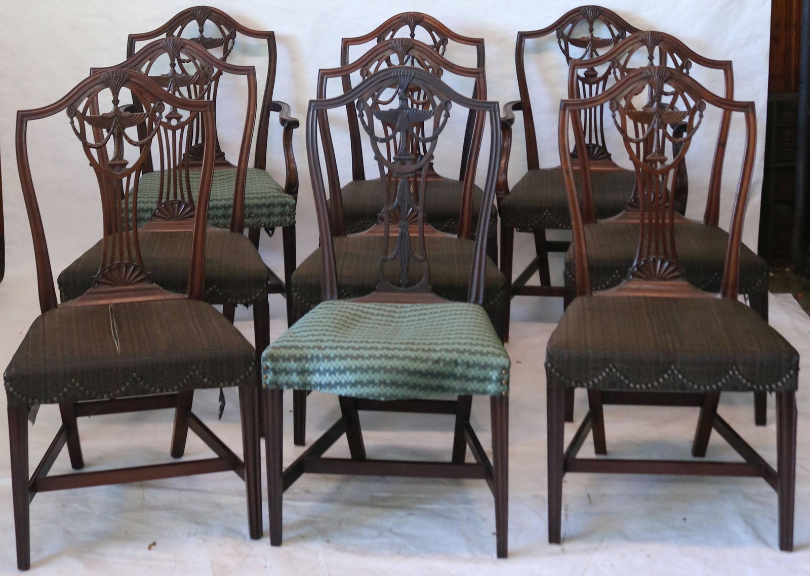 SET OF NINE MAHOGANY DINING CHAIRS. SIX ARE 18TH: CENTURY PROBABLY RI WITH ELABORATE URN AND GARLAND BACKSPLAT, FAN AT BOTTOM CREST, REEDED TAPERED LEGS, HORSEHAIR UPHOLSTERY. ONE SIDE CHAIR IS PERIOD, BUT SLIGHTLY DIFFERENT (DOES NOT HAVE FAN AT BOT