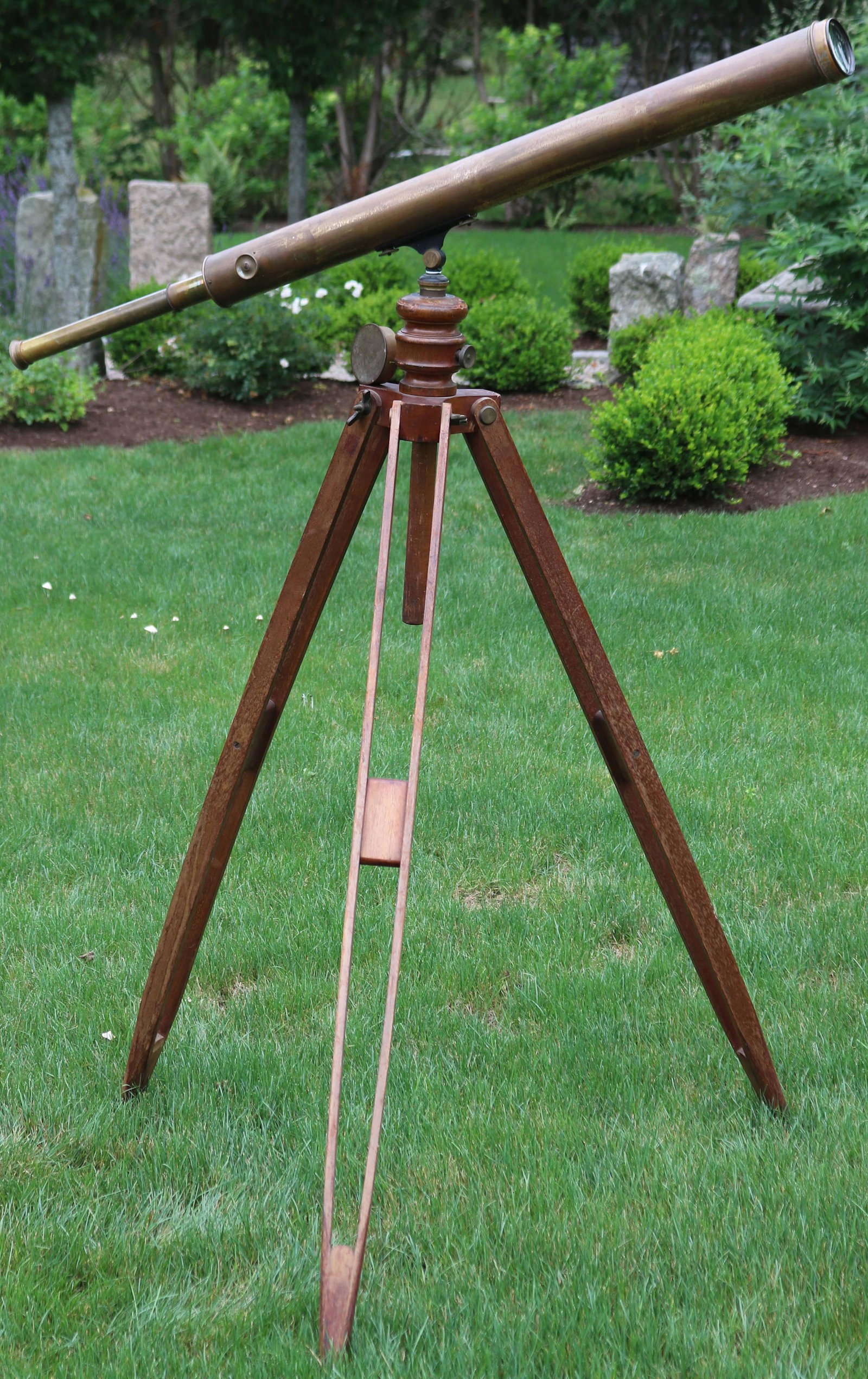 19TH CENTURY BRASS TELESCOPE ON A WOODEN TRIPOD: BASE. TELESCOPE MADE BY ANDREW LLOYD AND CO., BOSTON. TELESCOPE OVERALL LENGTH 57", CLOSED 38 3/4". RETAINS LENS CAPS. WOODEN TRIPOD BASE APPROXIMATELY 55" HIGH. HAS BRASS MOUNTINGS. BASE HAS OLD NATU