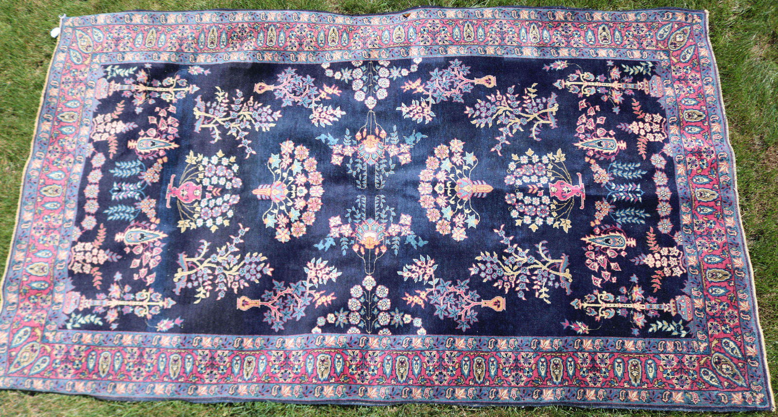 EARLY 20TH CENTURY PERSIAN BLUE SAROUK RUG. BLUE: FIELD WITH TREES, URN, AND FLORAL DESIGN. VERY SLIGHT WEAR. 51" X 88".