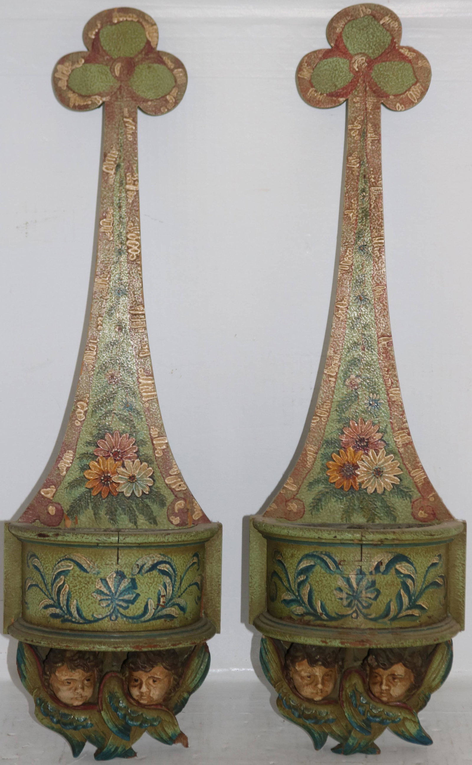 PAIR OF EARLY 20TH CENTURY CARVED AND PAINTED: ITALIAN SCONCES WITH TIN INSERTS FOR FLOWERS. PAINTED COMPOSITION CHERUBS. ONE WING IS CHIPPED. 24" HEIGHT, 7" WIDTH.