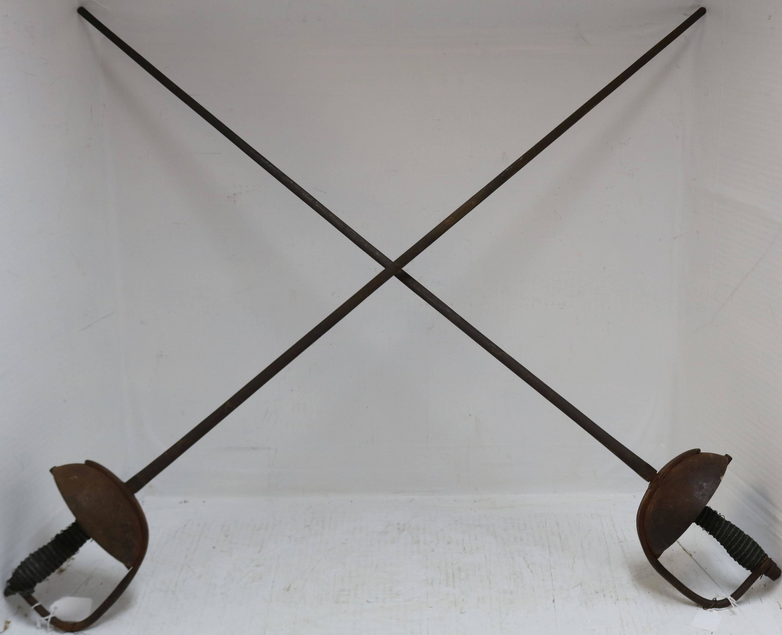 TWO 19TH CENTURY EUROPEAN WROUGHT IRON RAPIERS: WITH BRAIDED SHARKSKIN HANDLES. 41" LONG.