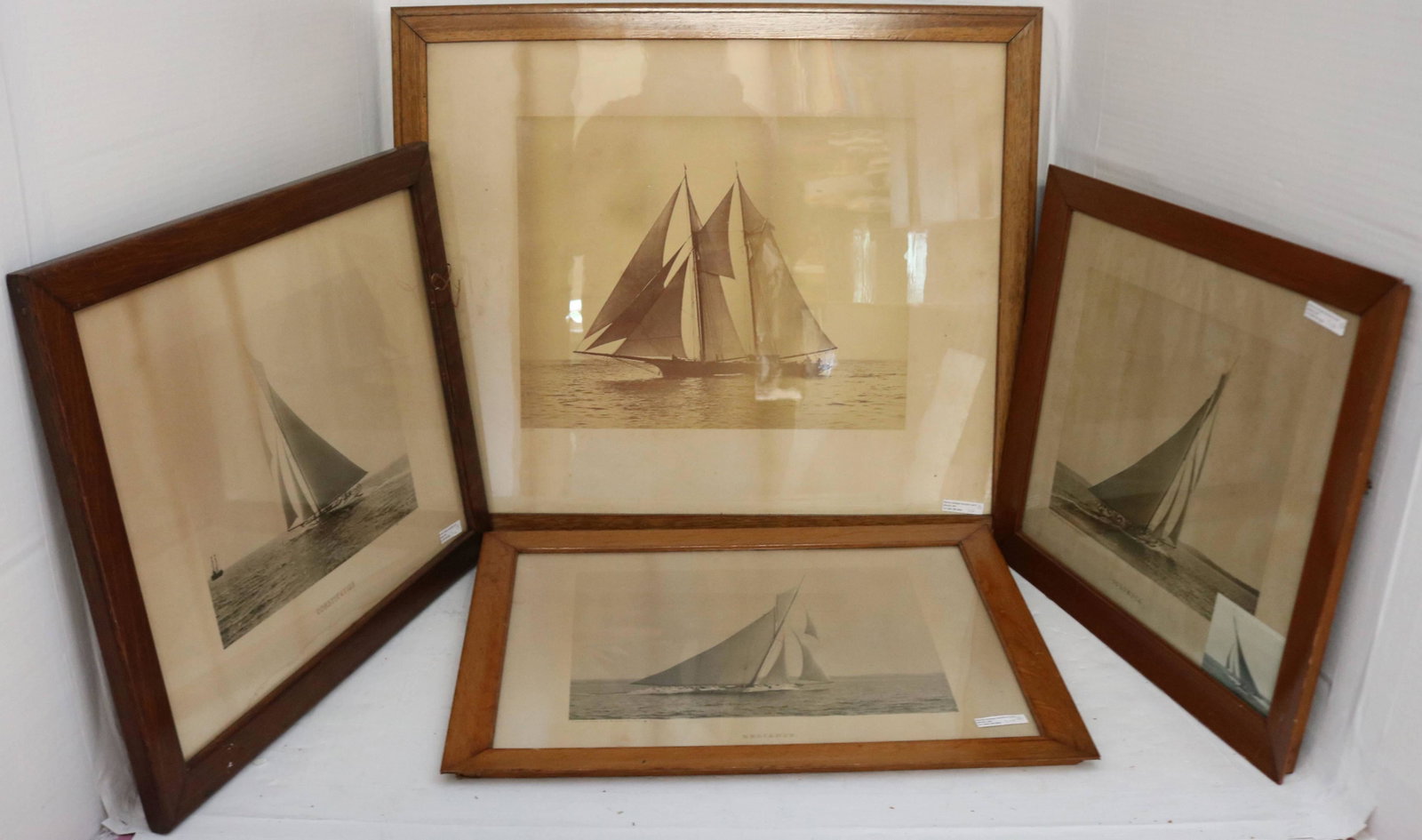 LOT OF THREE FRAMED PHOTOGRAVURES BY BOWLES, AND: ONE REAL SEPIA PHOTOGRAPH BY STEBBINS. CA. 1900. SOME POSSIBLY DEPICTING AMERICA'S CUP YACHTS. LOT TO INCLUDE: 1) "THE COLUMBIA" DATED 1899 BY C E BOLLES, BROOKLYN, NY, IN PERIOD OAK FRAME. SHOWS LIGH
