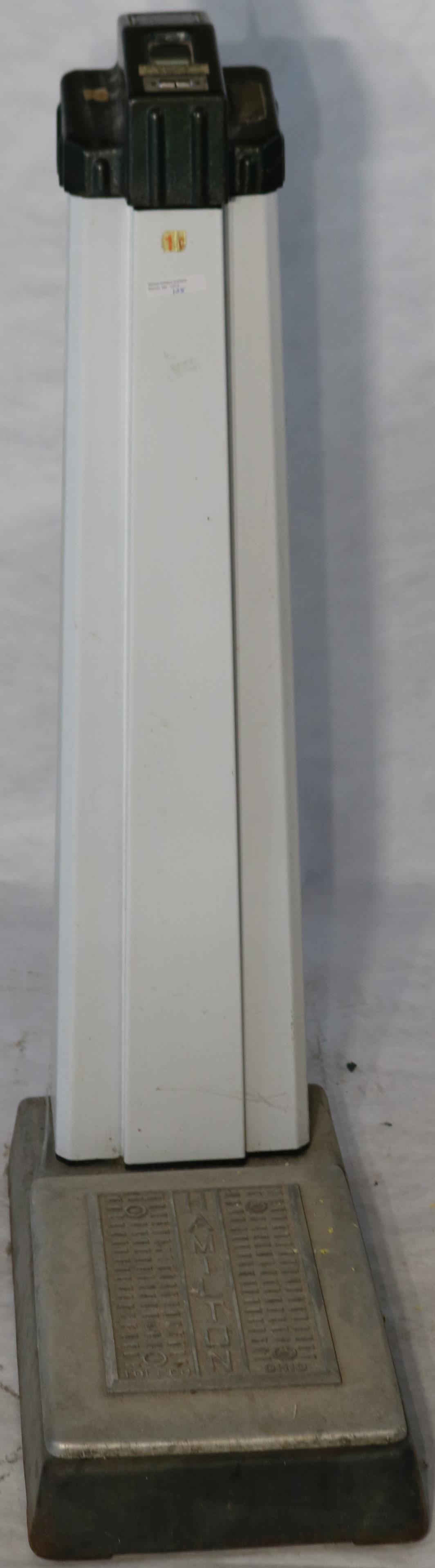 HAMILTON PENNY OPERATED ENAMEL OVER METAL SCALE.: 40 1/2" HIGH, 11" WIDE, 21 1/2" DEEP. GOOD CONDITION, NO KEY. WORKING CONDITION.