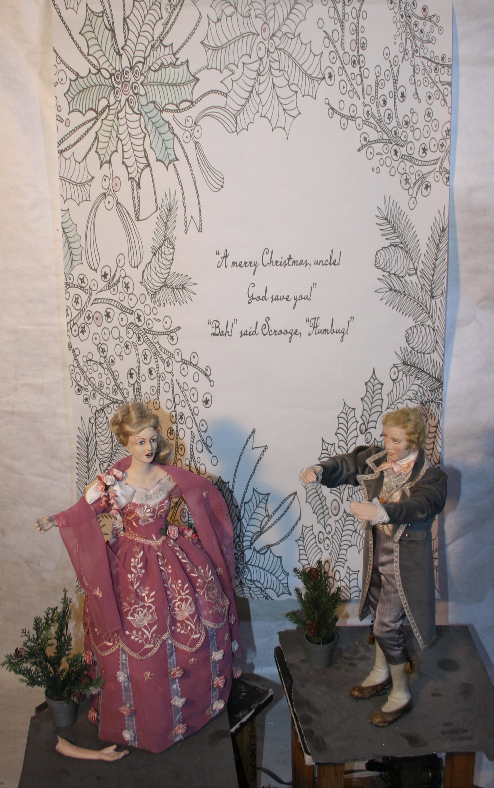 TWO MID-20TH CENTURY DICKENSIAN CHARACTER: AUTOMATONS OF AN ELEGANTLY DRESSED COUPLE, POSSIBLY BY SILVESTRI ART MANUFACTURING CO. MAN IS 20" TALL, AND 33" TALL WITH HIS 14" X 13" DAMAGED LINOLEUM STAND. THE WOMAN IS 22" TALL, AND 33" TALL OVER
