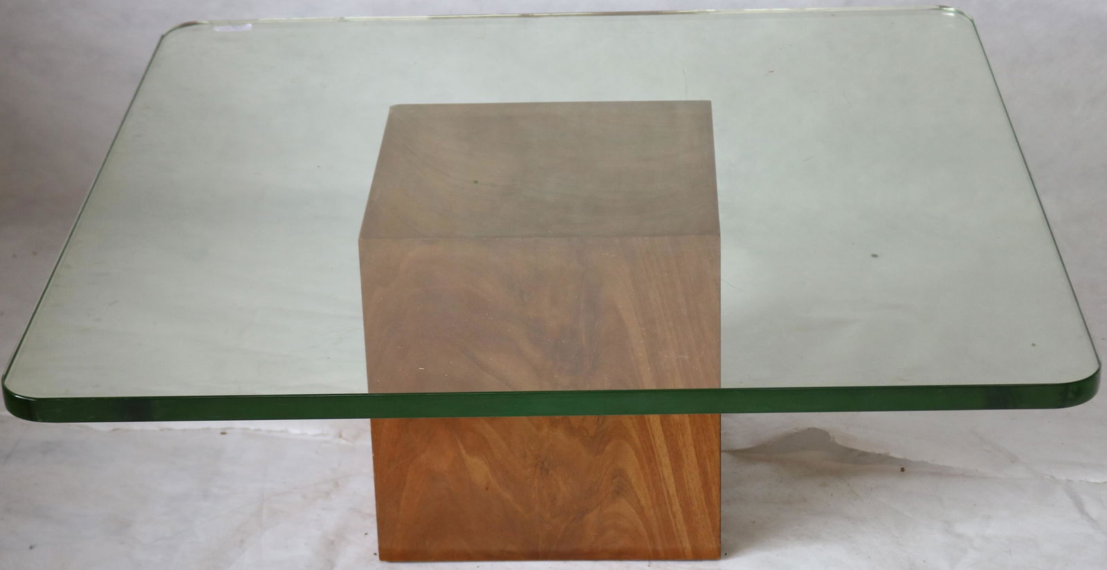 MID-CENTURY DUNBAR GLASS TOP COFFEE TABLE. WALNUT: BASE WITH HEAVY PLATE GLASS SQUARE TOP. 15 1/2" HIGH, 38" X 38" TOP. GLASS IS 1" THICK.