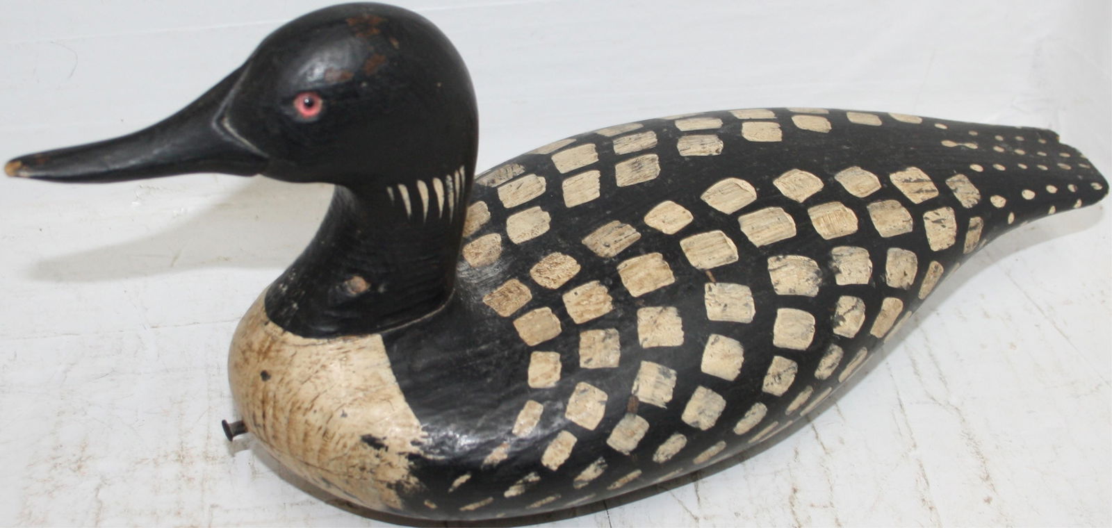 MID-20TH CENTURY SPOTTED DUCK DECOY, SIGNED RDP: ?. NICE ORIGINAL PAINT. TAIL HAS A LARGE CHIP. 6 1/2" HIGH, 14" LONG, 6 1/2" WIDE.