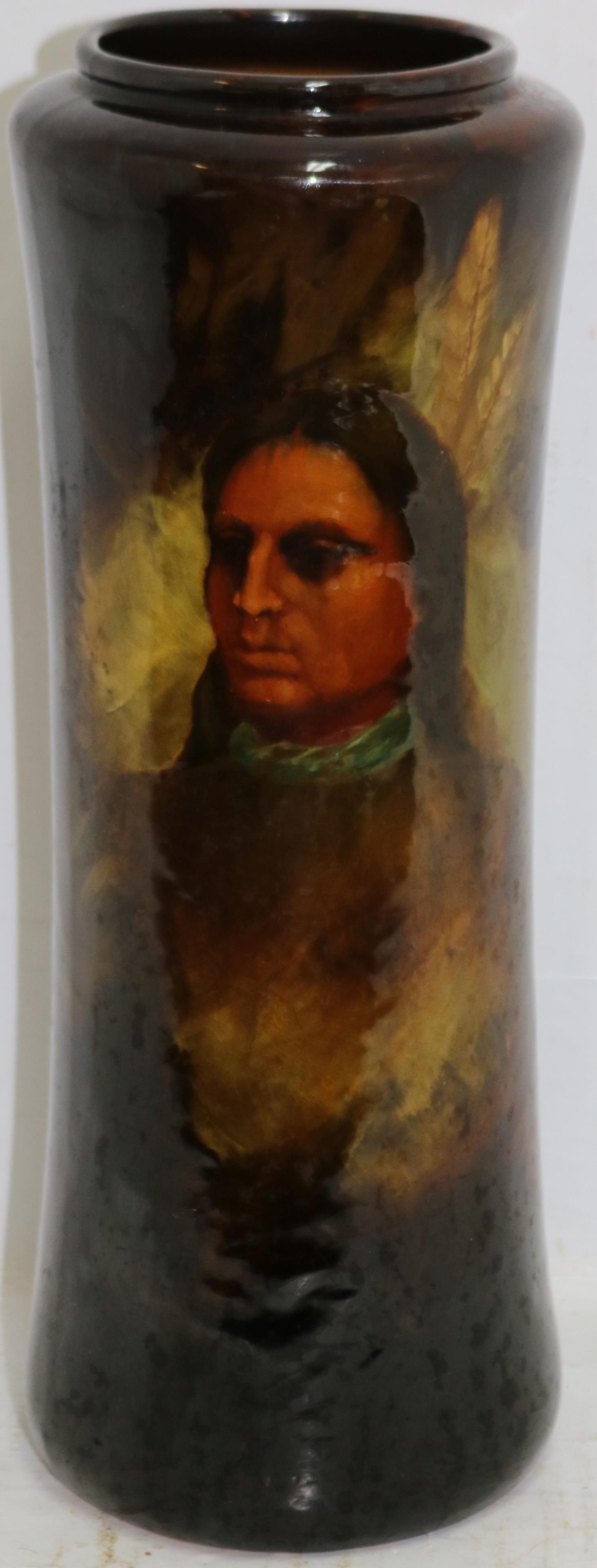LOUWELSA WELLER POTTERY VASE, WITH PORTRAIT OF: NATIVE AMERICAN, SIGNED BY THE ARTIST K COYLEONE. 12" HIGH, APPROX. 4 1/2" DIAMETER. MINOR CRAZY.