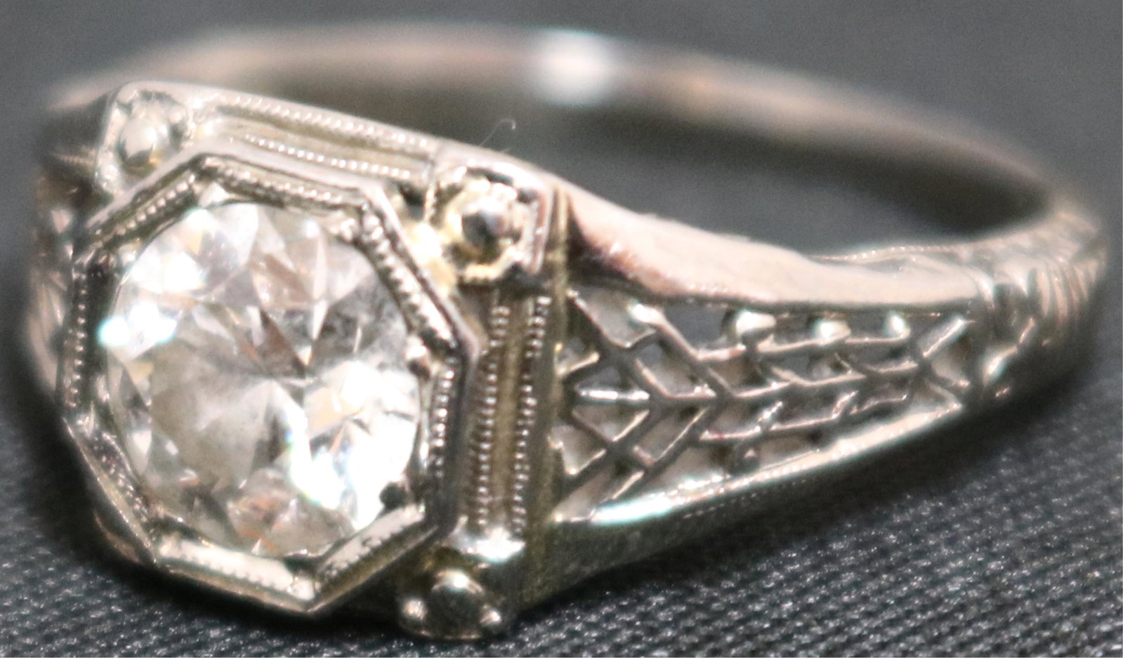 18KT WHITE GOLD RING, WITH APPROX. 1 + CT DIAMOND: SOLITAIRE IN A FILIGREE SETTING. SIZE 5. 1.4 DWT INCLUSIVE.