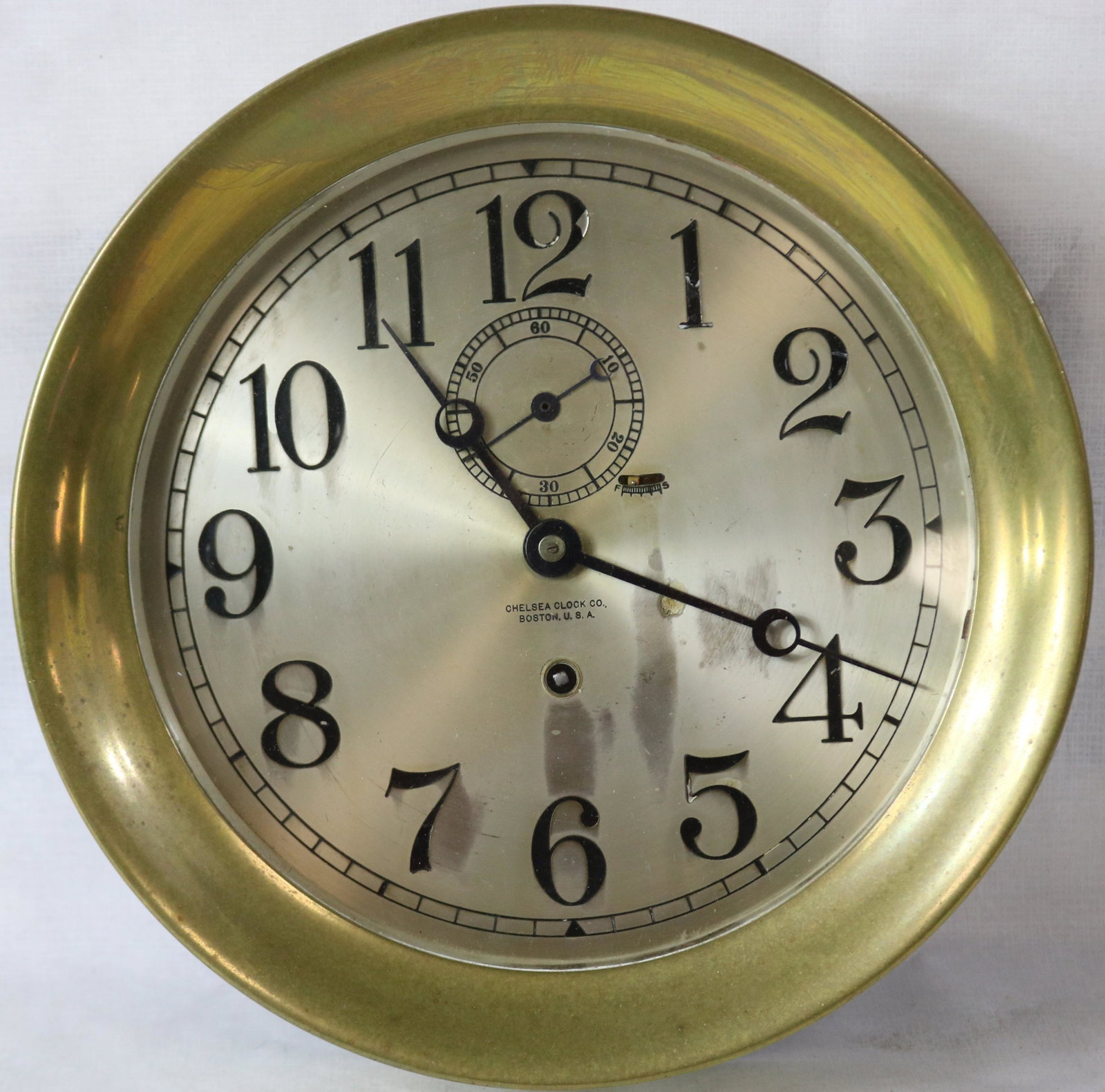 ROUND CHELSEA SHIP'S CLOCK, BRONZE WITH SILVER: DIAL. CURRENTLY IN WORKING CONDITION. 11" DIAMETER. 3" DEEP. #130241.