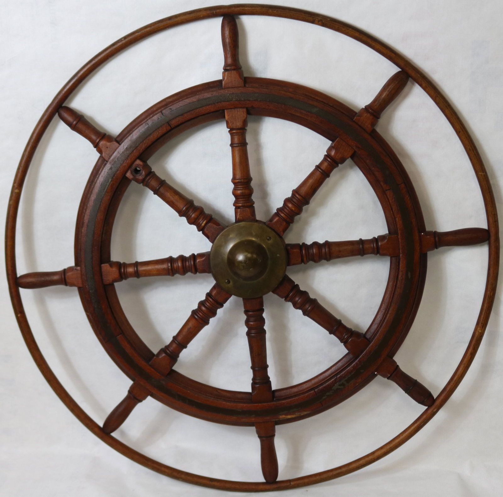 EARLY 20TH CENTURY HARDWOOD BRASS AND IRON SHIPS: WHEEL WITH OUTER RING. 8 SPOKES WITH NICELY TURNED SHAFTS. GOOD ORIGINAL NATURAL FINISH. BRASS RING AND BRASS HUB. 45" DIAMETER