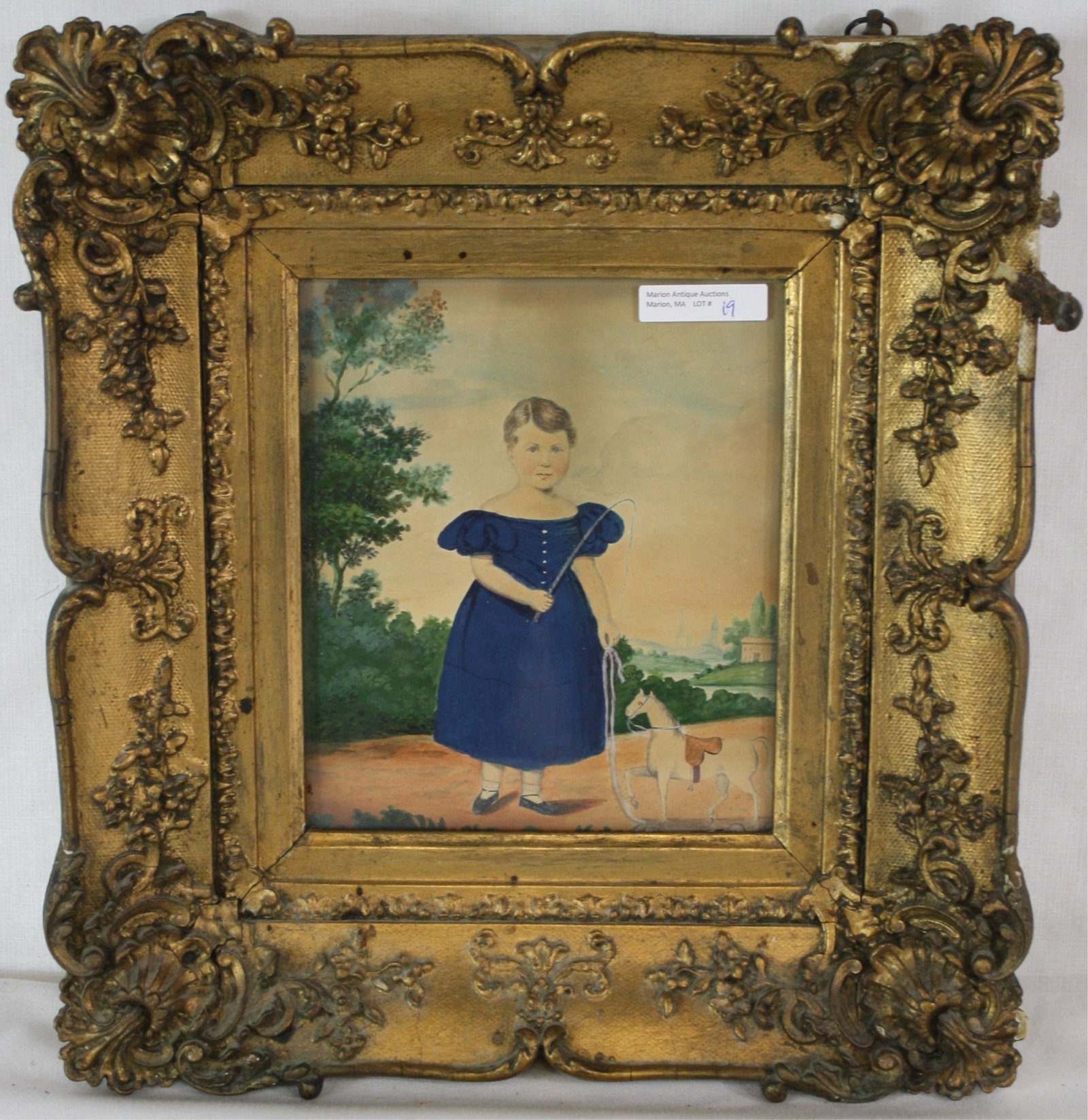 EARLY 19TH C. FOLK ART WATERCOLOR, DEPICTING A: YOUNG GIRL IN BLUE DRESS CARRYING TOYS, WHICH INCLUDE A WHIP, STANDING NEXT TO HER HORSE PULL TOY. RIVERSCAPE WITH HOUSES AND CHURCH IN BACKGROUND. SIGHT SIZE 8" X 6 1/2", OVERALL WITH PERIOD FRAME 14