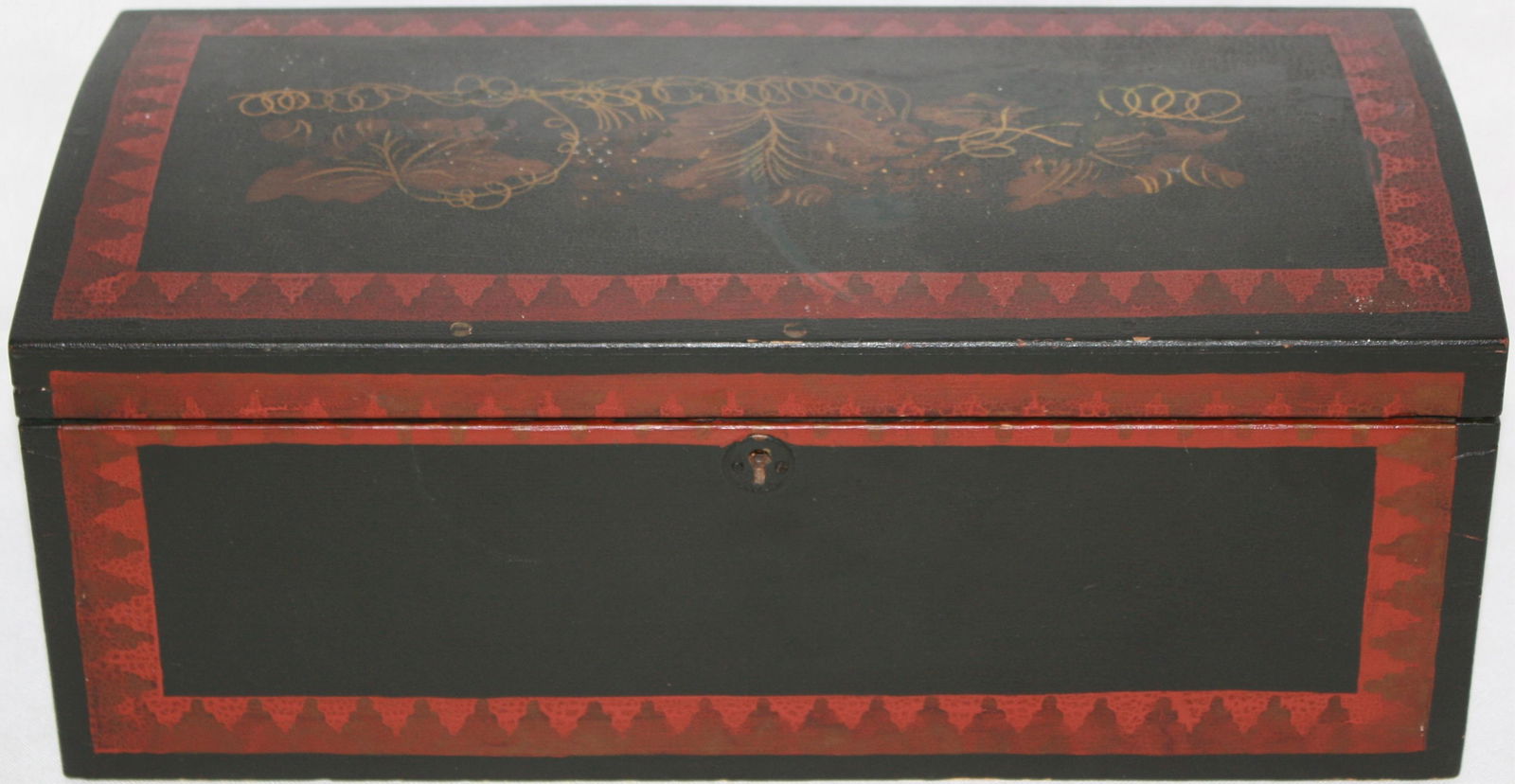 EARLY 19TH CENTURY PAINT DECORATED DOME TOP: DOVETAILED DOCUMENT BOX. LEAF AND VINE DESIGN WITH RED GEOMETRIC DECORATED BORDERS WITH KEY. SHOWS OVER VARNISHED FINISH. 6 1/2" HIGH, 15 3/4" WIDE, 7 3/4" DEEP.