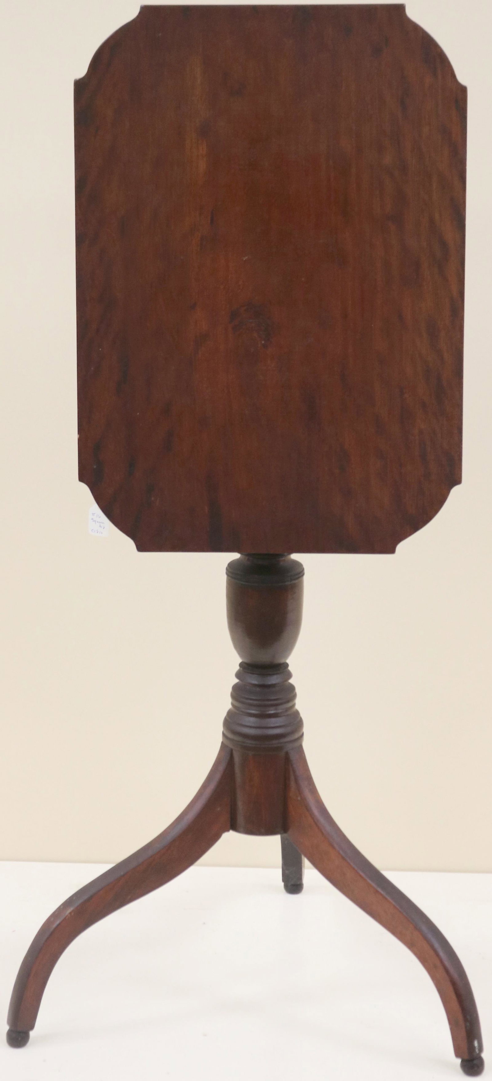 AN EARLY 19TH CENTURY AMERICAN CHERRY TIP-TOP: CANDLE STAND IN THE HEPPLEWHITE STYLE CUT CORNERS TURNED SHAFT SPIDER LEGS AND BALL FEET. NEW ENGLAND GOOD CONDITION OLD FINISH. 28 1/2" HIGH, 19 3/4" WIDE, AND 14" DEEP. BASE 19 1/2" DIAMETER.