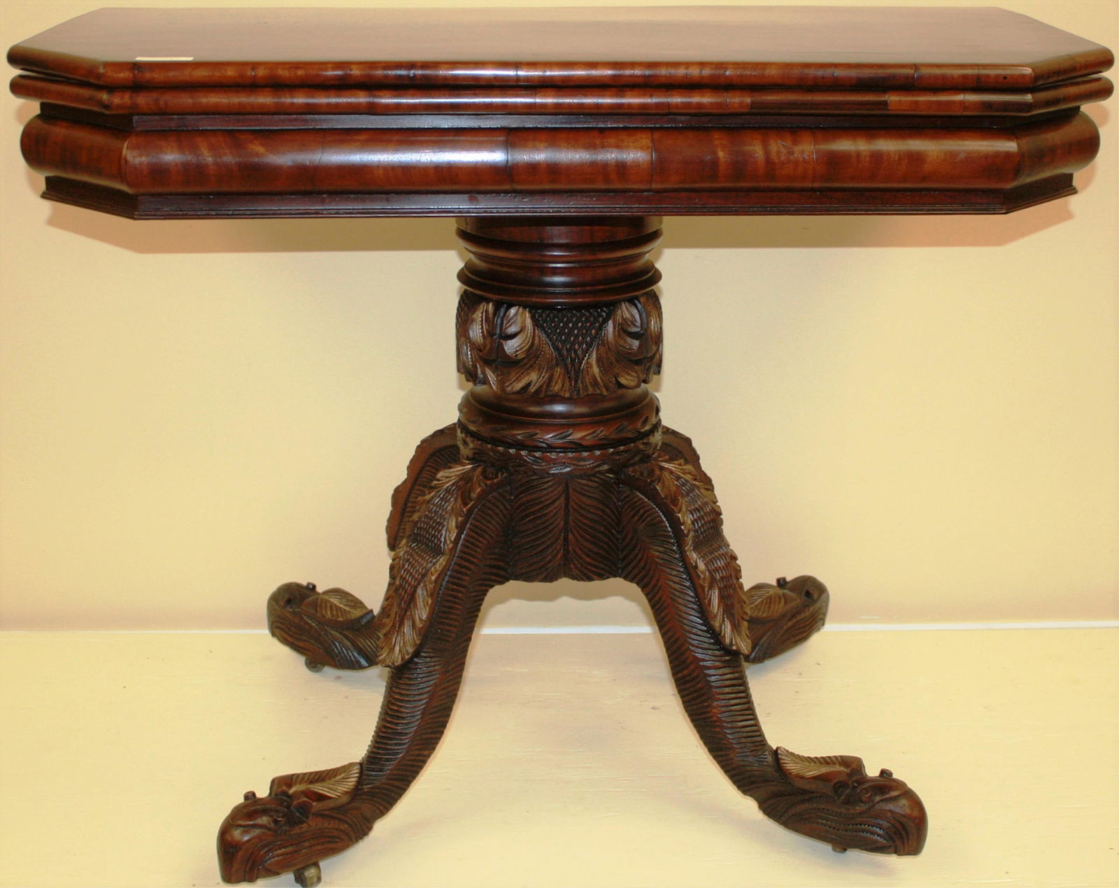 EARLY 19TH CENTURY AMERICAN CARD TABLE, POSSIBLY: NEW YORK, ALBANY AREA. HAS A D SHAPED TOP, WITH EXTREMELY UNUSUAL AND ELABORATELY CARVED BASE. EAGLE HEAD FEET, ACANTHUS LEAF CARVING. EXCELLENT REFINISHED CONDITION. 30" HIGH, 37" WIDE, 18" DEEP WHEN