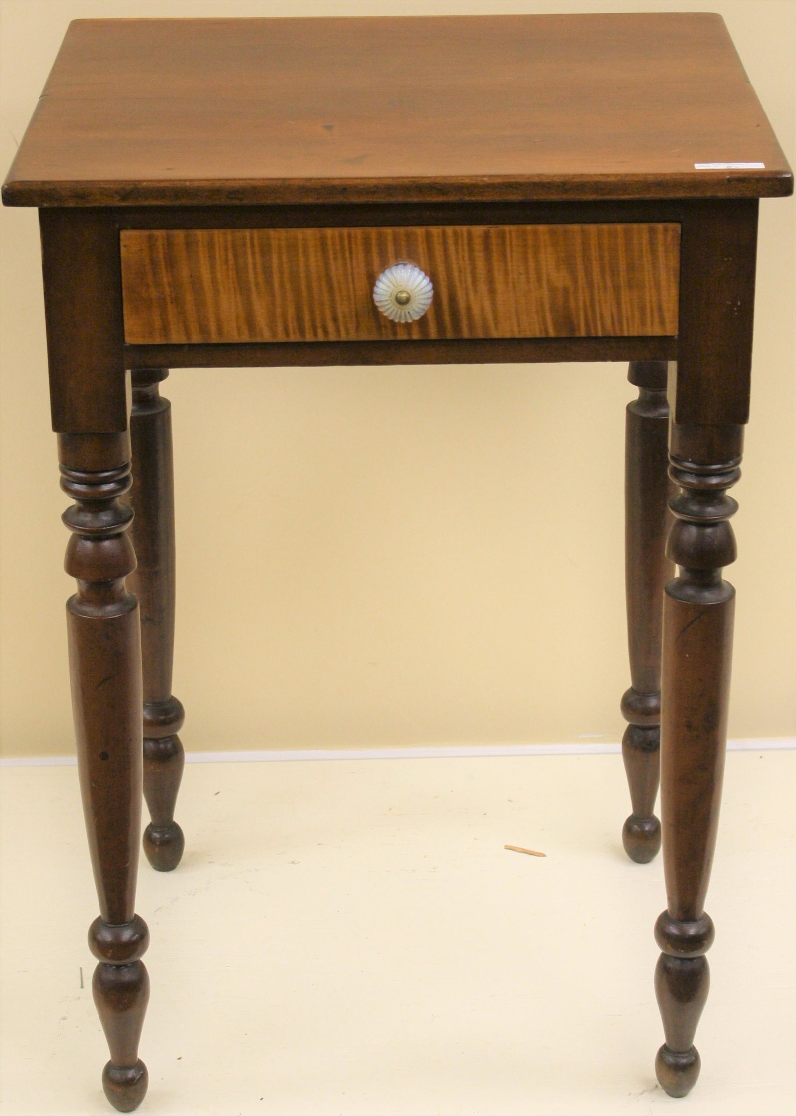 EARLY 19TH CENTURY ONE DRAWER STAND, AMERICAN,: NICELY TURNED LEGS. CHERRY, TIGER MAPLE DRAWER FRONT, OLD REFINISHED CONDITION. SANDWICH GLASS DRAWER PULL. 29" HIGH, 20" WIDE, 17 1/2" DEEP.