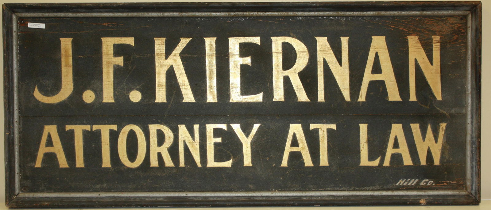 HAND PAINTED LATE 19TH CENTURY WOODEN SIGN. "J.: F. KIERNAN, ATTORNEY AT LAW". KIERNAN WAS A WELL-RESPECTED WAREHAM, MA ATTORNEY. 22" X 50", 2 3/4" DEEP. OVERALL WEAR CONSISTENT WITH AGE.