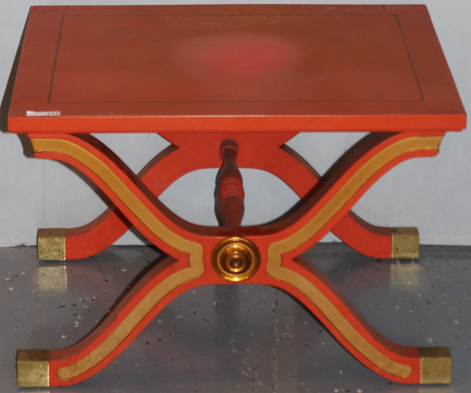 DOROTHY DRAPER FOR HERITAGE HENREDON, X-BASE: ESPAÃ‘A TABLE WITH BRASS MEDALLION. HOLLYWOOD REGENCY. 16" HIGH, 24" WIDE, 19 1/4" DEEP. THIS SIDE TABLE CAN ALSO BE USED AS A STOOL. TOP SHOWS SOME DISCOLORATION AND FADING TO PAINT.