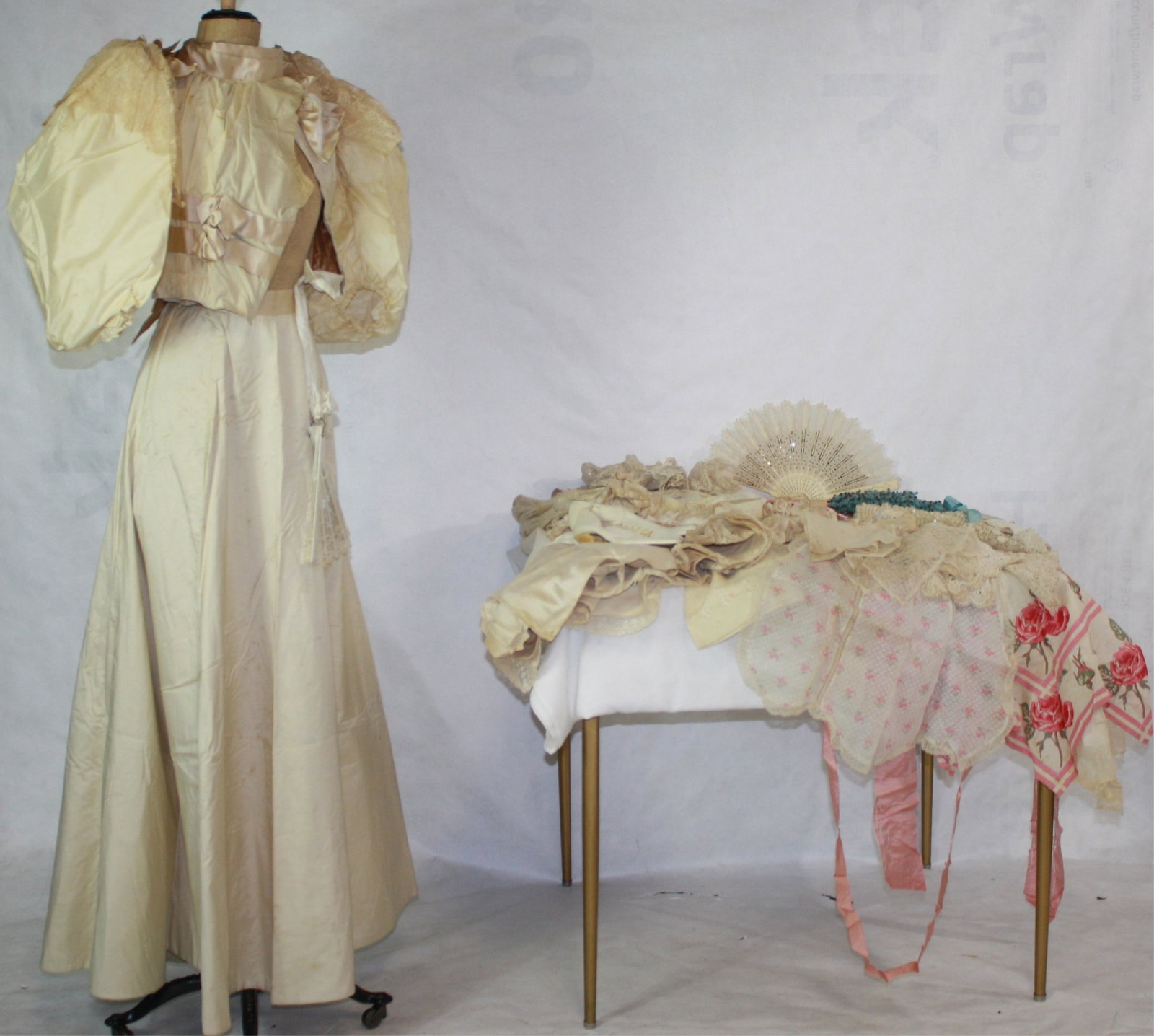 LOT OF 1890S VICTORIAN TROUSSEAU GARMENTS AND: ACCESSORIES, TO INCLUDE: CA. 1895 WEDDING GOWN, FINE WOOL SILK BLEND, WITH LACE FLOUNCES ON THE SHOULDERS. TWO CORSET COVERS, ONE COTTON PETTICOAT AND ONE WOOL PETTICOAT, A PAIR OF SPLIT DRAWERS, WHIT