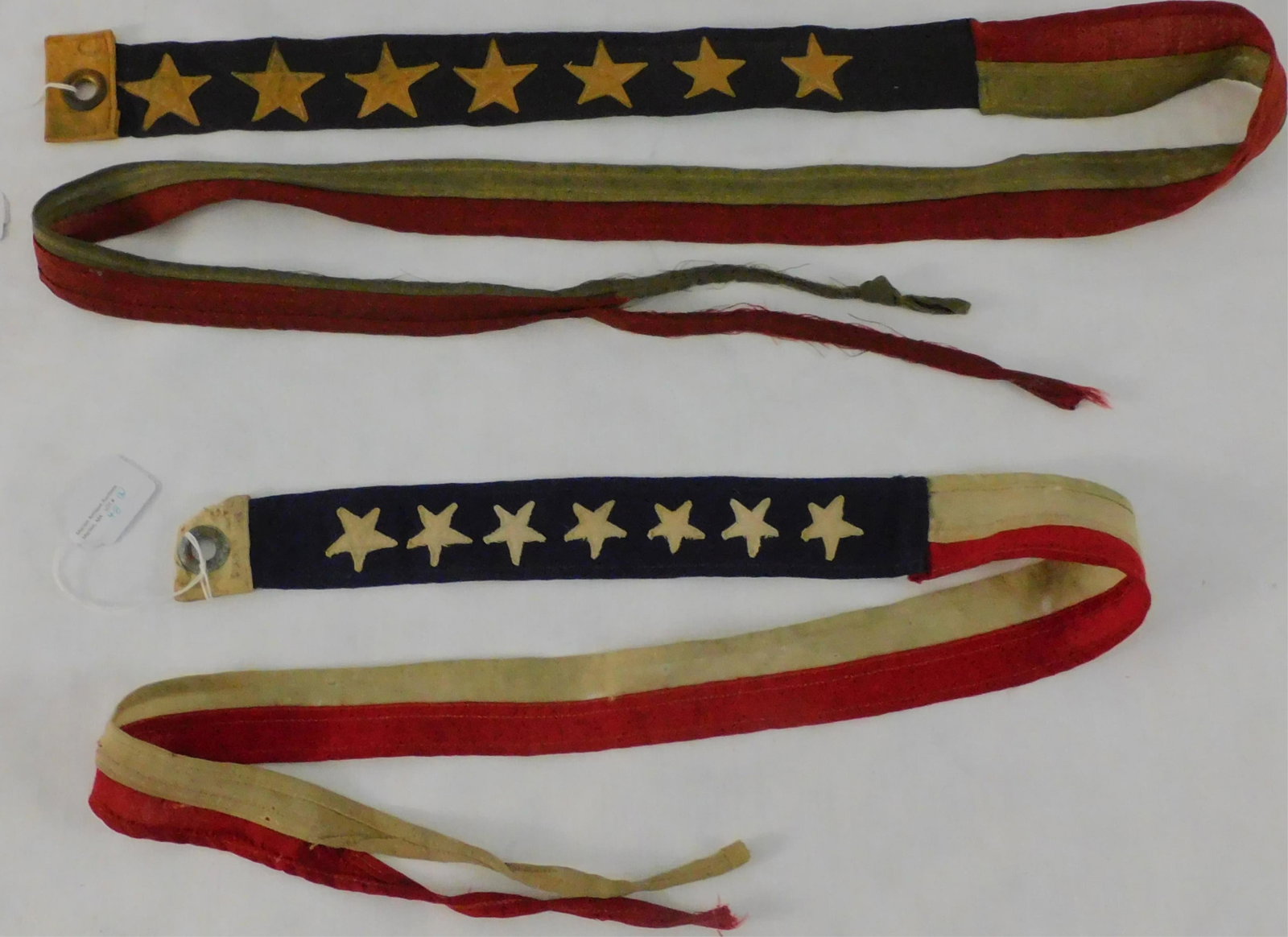 Two seven-star US Navy Commissioning pennants.: These are early US Navy 7-star commissioning pennants, ca. 1895-1918. Wool. 48" long, 2" at widest point. Other is 71" long, 2 1/2" at widest point. Overall good condition, minor holes and fraying. Lo