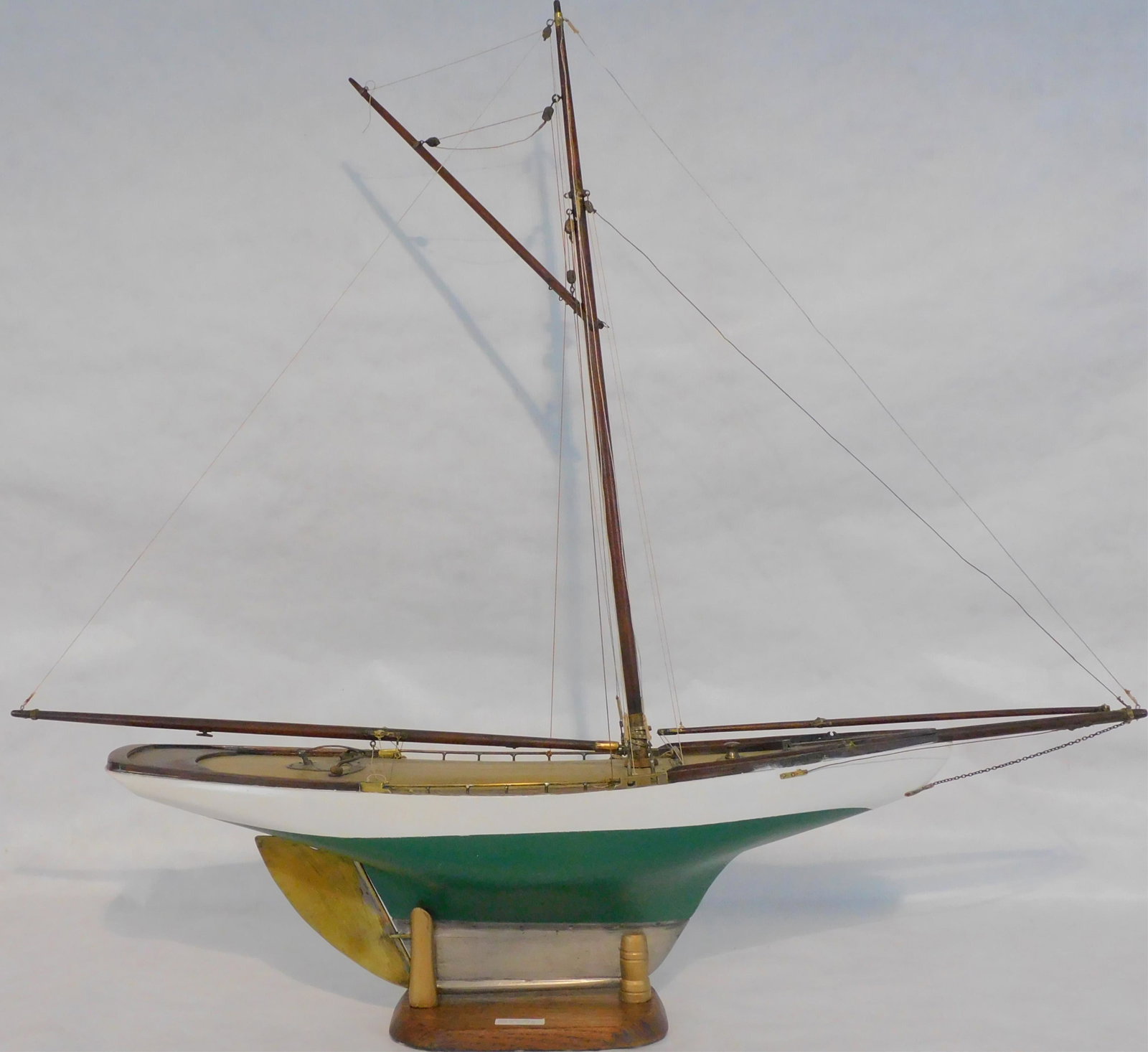 Early 20th century pond model, fully rigged. Brass: rudder, leaded keel. Repainted finish. Natural wooden mast and spars. Custom stand. 37 1/2" high, 8" wide, 41" long. Excellent overall condition.