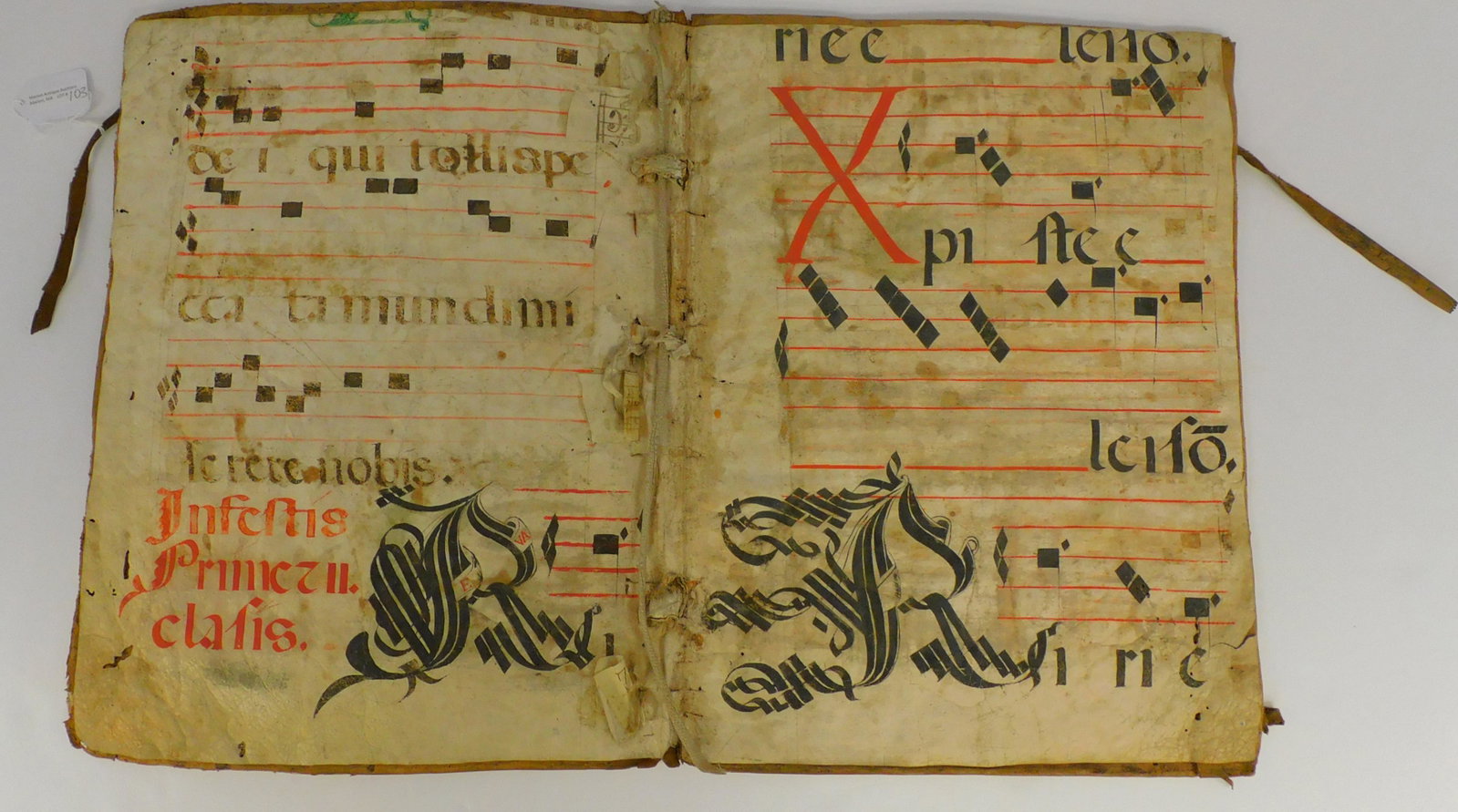 17th / 18th century illuminated sheet music: housed in an early fold out vellum case. Opens to two pages of sheet music. Also sealed and enclosed in the cover are two more sheets. Shows staining and discoloration. 16 1/2" x 12".