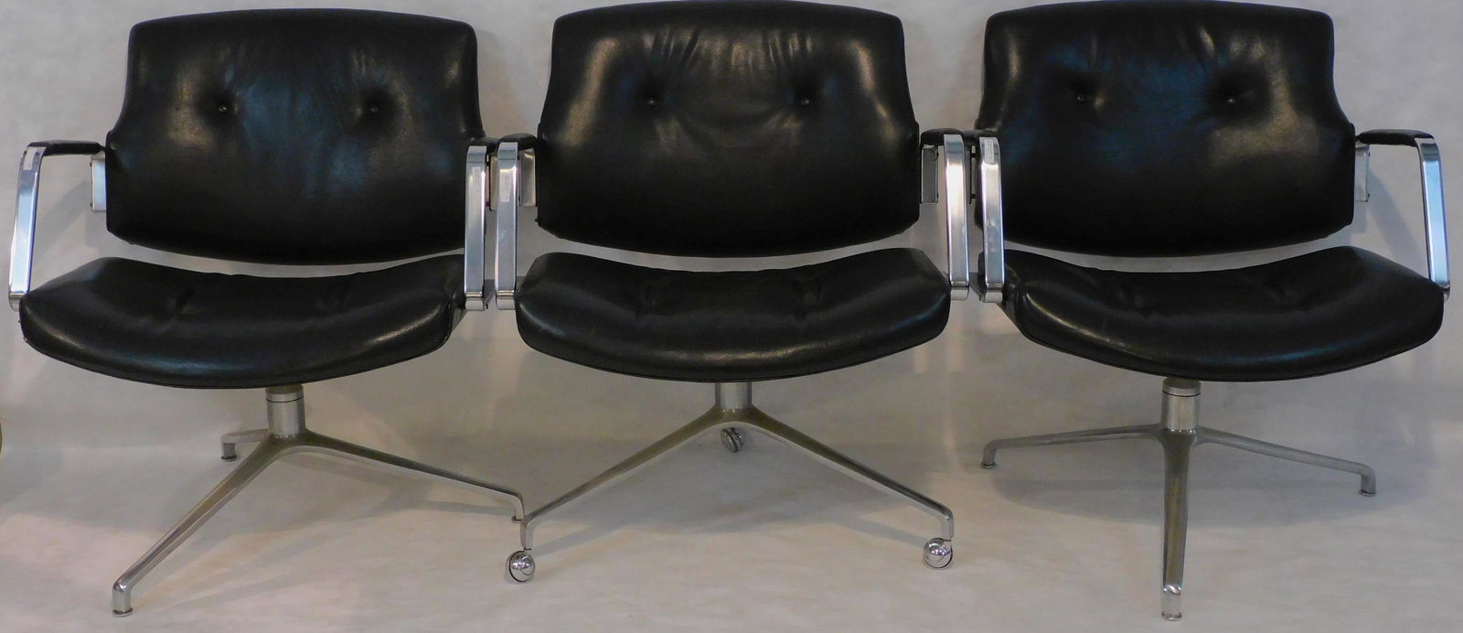 Preben Fabricius (1931-1984) and Jorgen Kastholm: (1931-2007) three model Fk84 armchairs, Denmark. Designed 1965. Labeled on bottom. Aluminum, matte chrome plated steel, and black leather. One chair is on casters. 28" wide, 32" high, 19" deep, 16 1/2