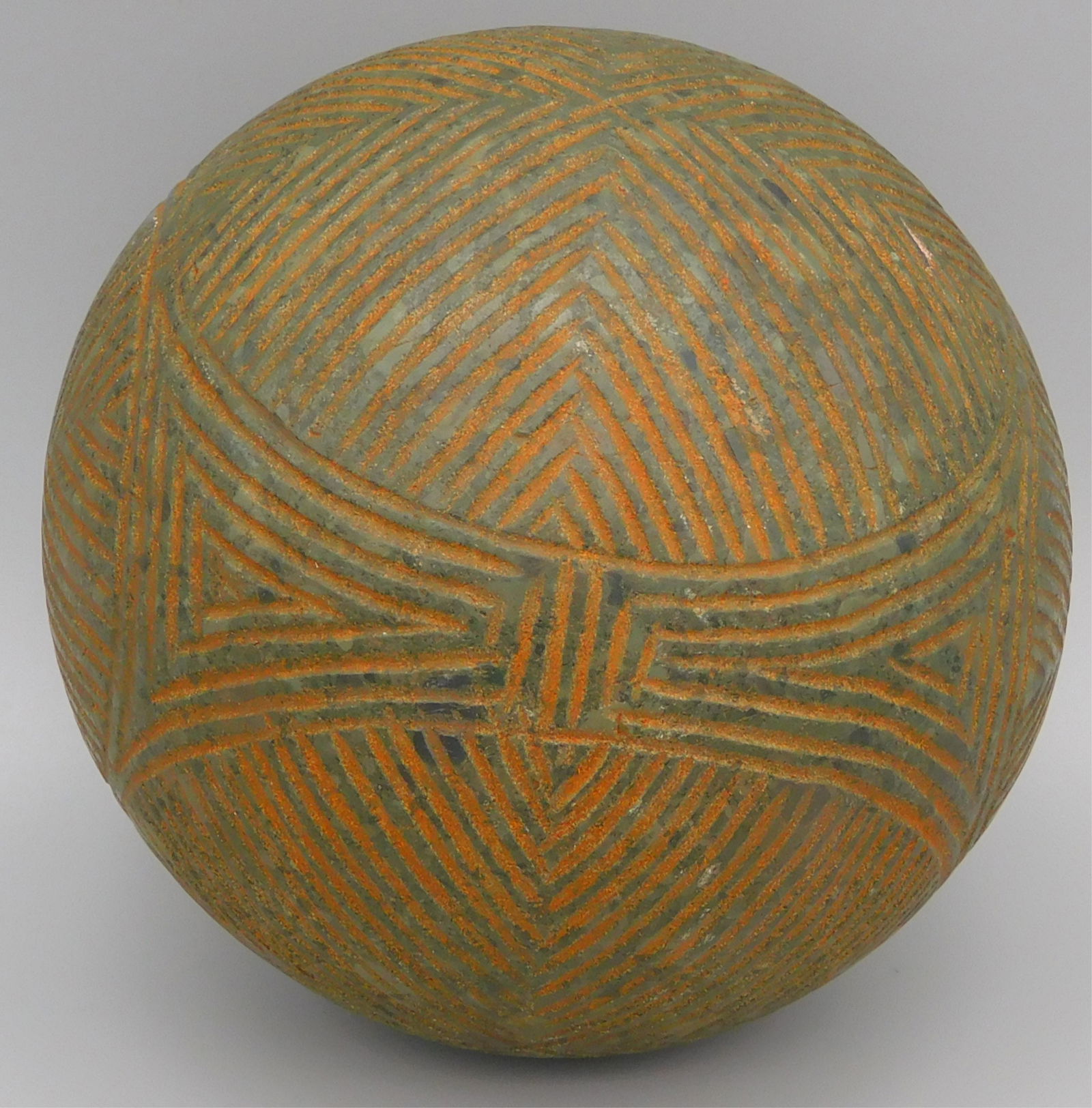 Incised Taino gaming ball. Fully incised with a: complex geometric pattern of circles surrounding 4 triangulate designs that symbolize the world's quadrants or 4 corners, I.e. N. S. E. and W. Provenance: Private Florida collection. Larry Roberts Col