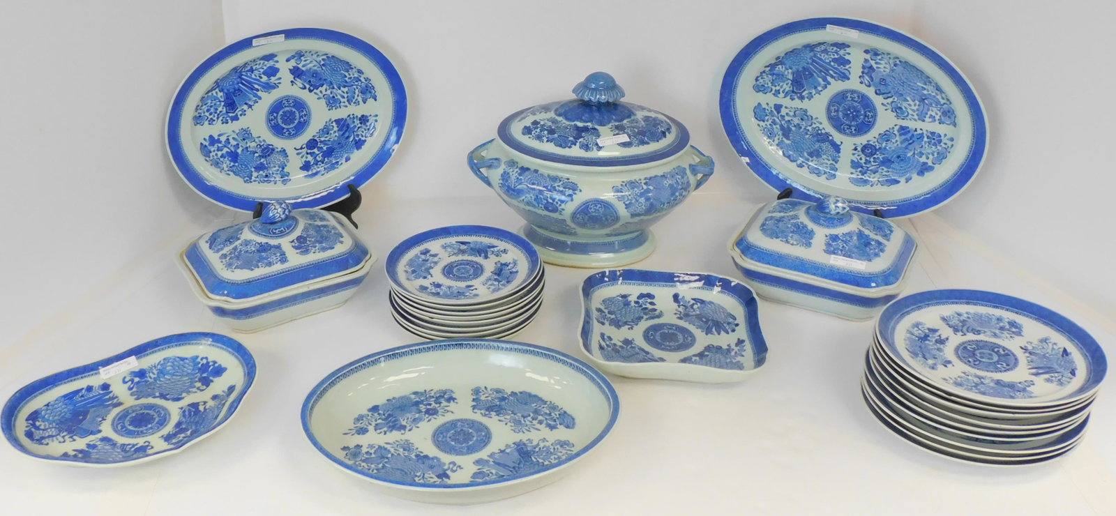 26 pieces of Chinese export porcelain, blue &: white floral design. Nine 9 1/2" plates (4 with chips), nine 8" plate (5 with chips), 14" oval bowl. Two 9 1/2" covered tureens, 15" and 13 1/2" platters, 14" wide x 10" high covered tureen. 9" square
