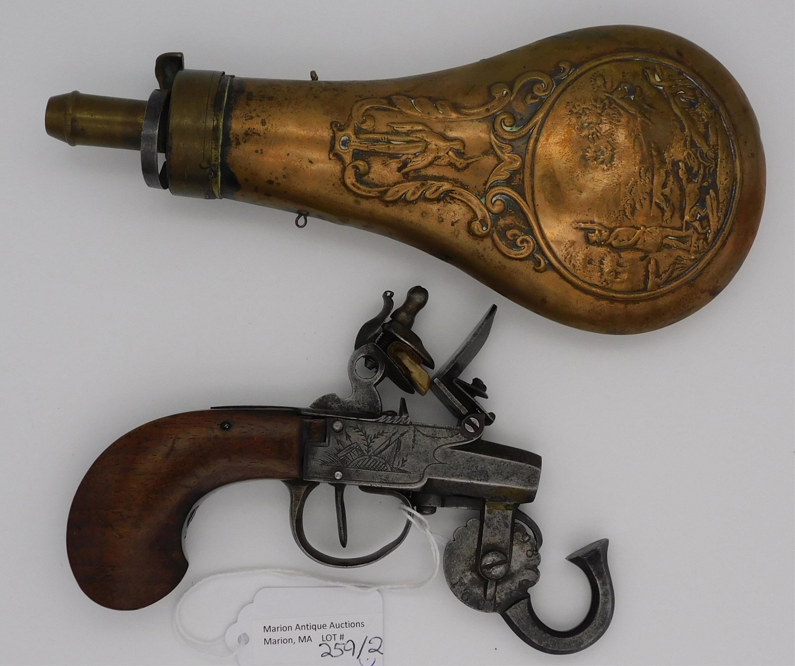 18th century English powder tester along with: early 19th century embossed powder flask. Powder tester is 4" high, 6" long. The flask is 3 1/2" wide, 8" high.