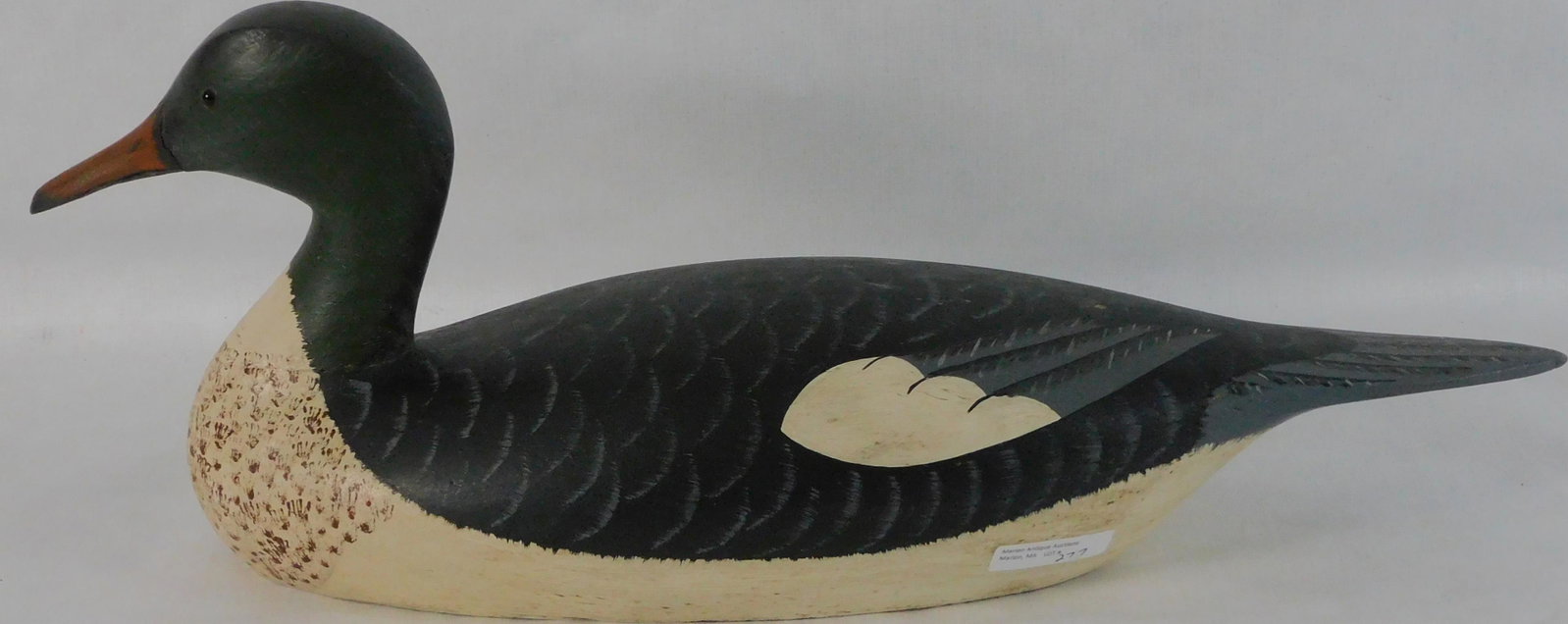Byron E. Bruffee (1942-2013, MA) carved and: painted American Merganser duck. Excellent original condition. Signed on bottom of tail. 21" long, 8 1/2" high, 7" wide.