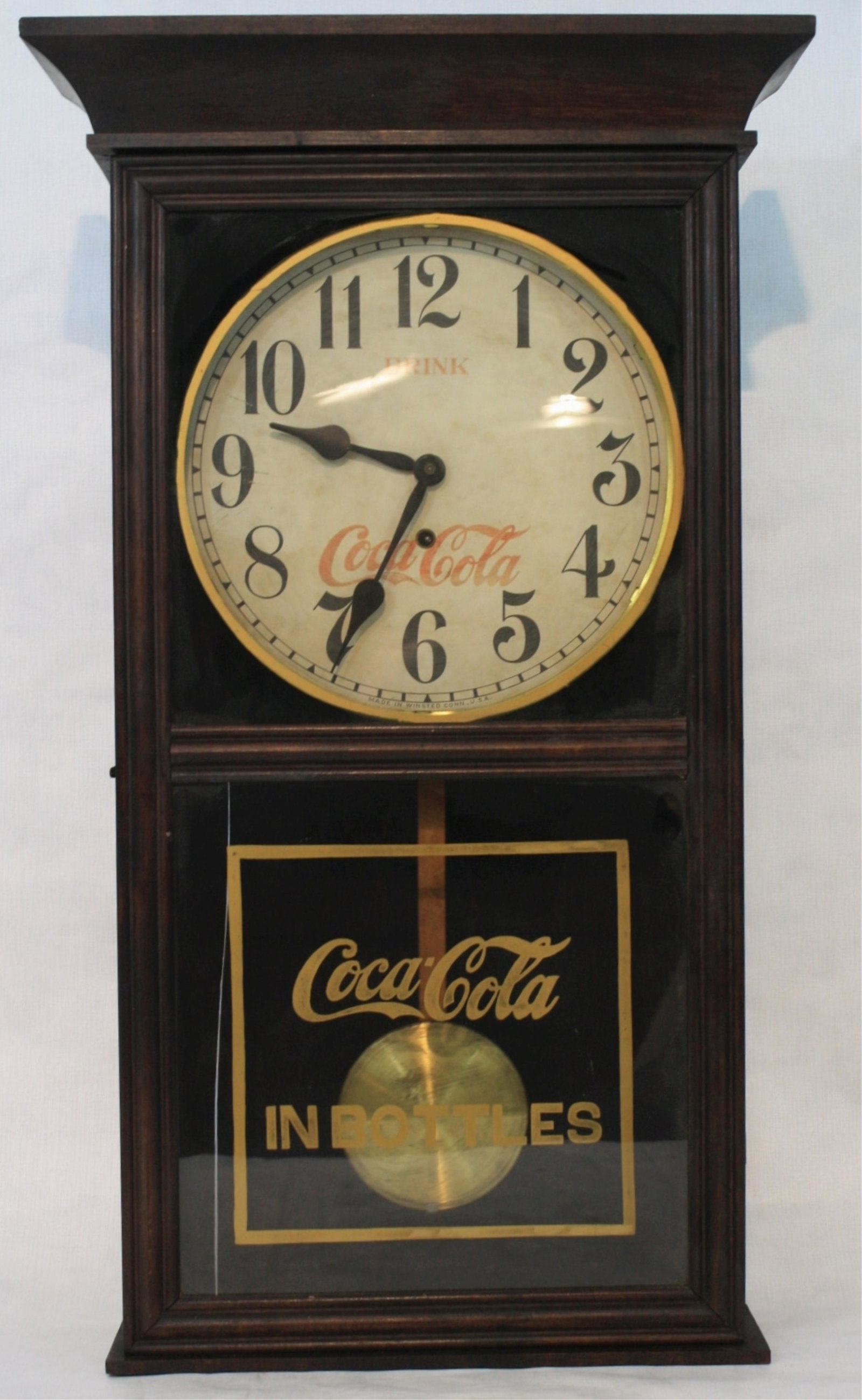 Coca Cola regulator wall hanging advertising: clock, early 20th century Winstead, CT. Key wound. Missing two pieces of trim to base. Bottom glass has had possible restoration. 30 3/4" high, 17 3/4" wide, 5 3/4" deep.