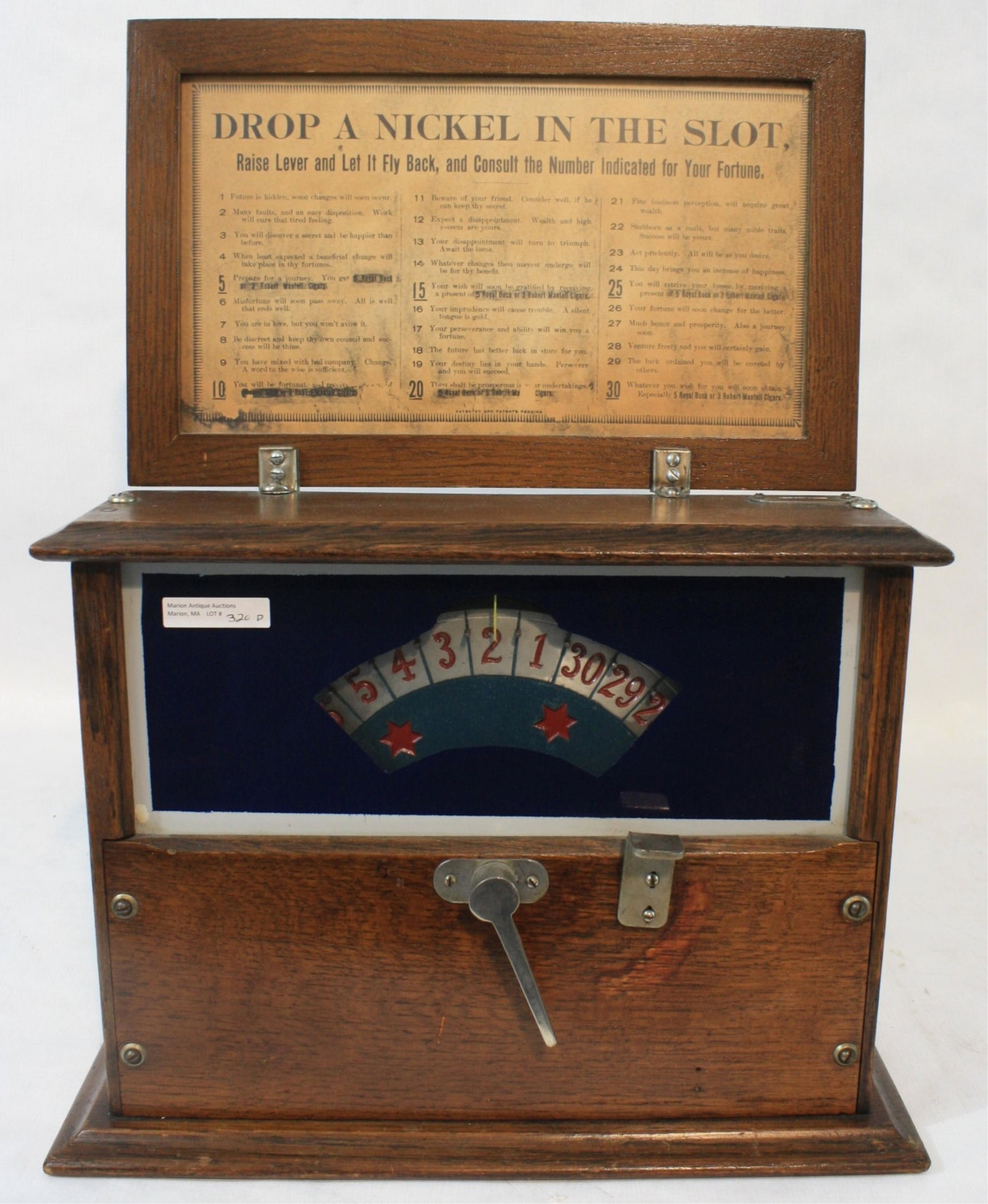 Oak gambling machine trade stimulator, ca. 1900.: For stimulating the sale of cigars. Original finish, has key. Currently is working. Takes nickels only. Probably manufactured by Griswold. 19 3/4" high, 15 1/2" wide, 5 1/2" deep.