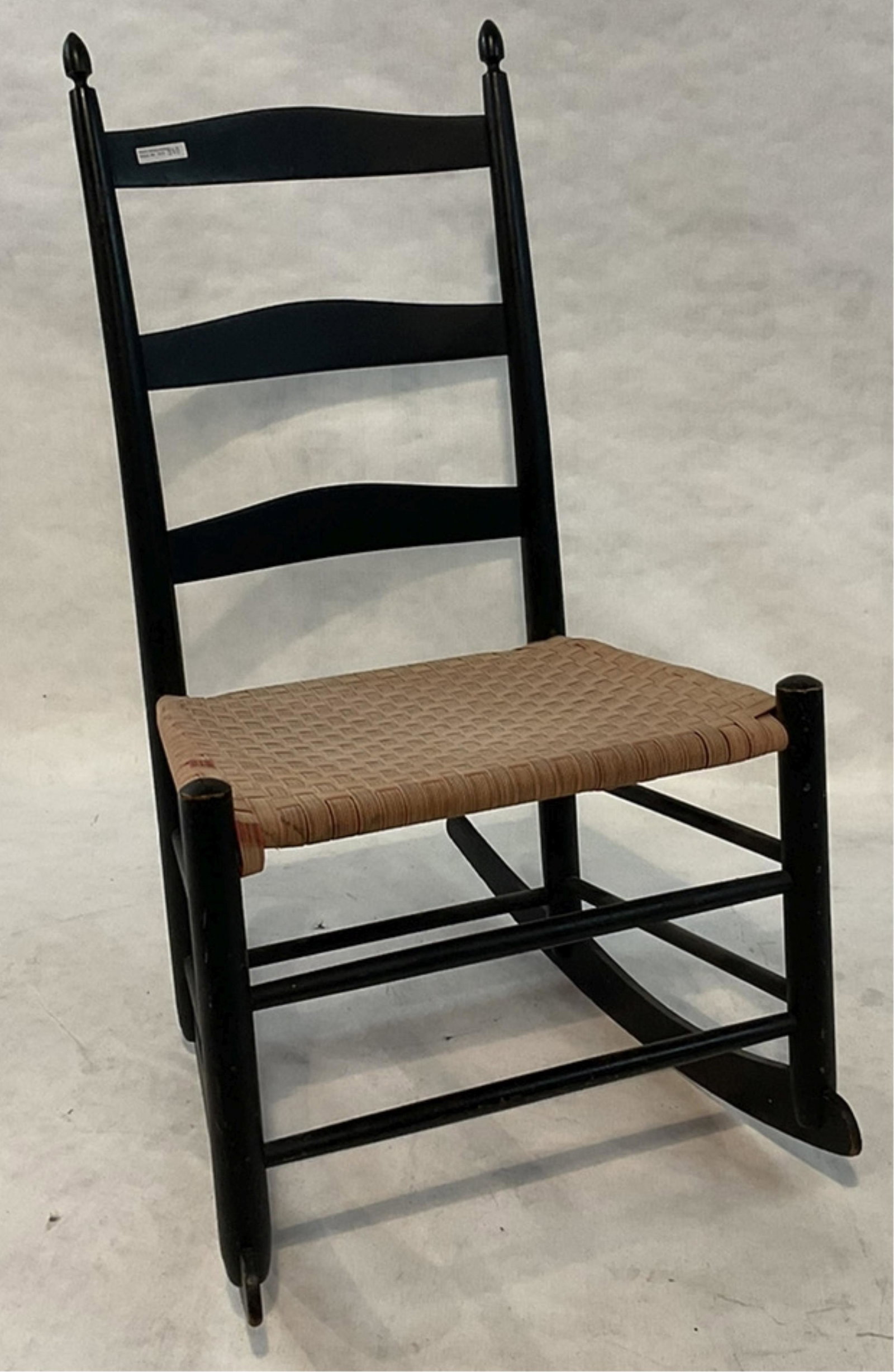 Shaker no. 3 armless rocker, black painted finish: with old tape seat. Stamped no. 3, no decal. Mount Lebanon, NY. 34 1/2" high, 19 1/2" wide, 24" deep, 15 1/2" seat height.