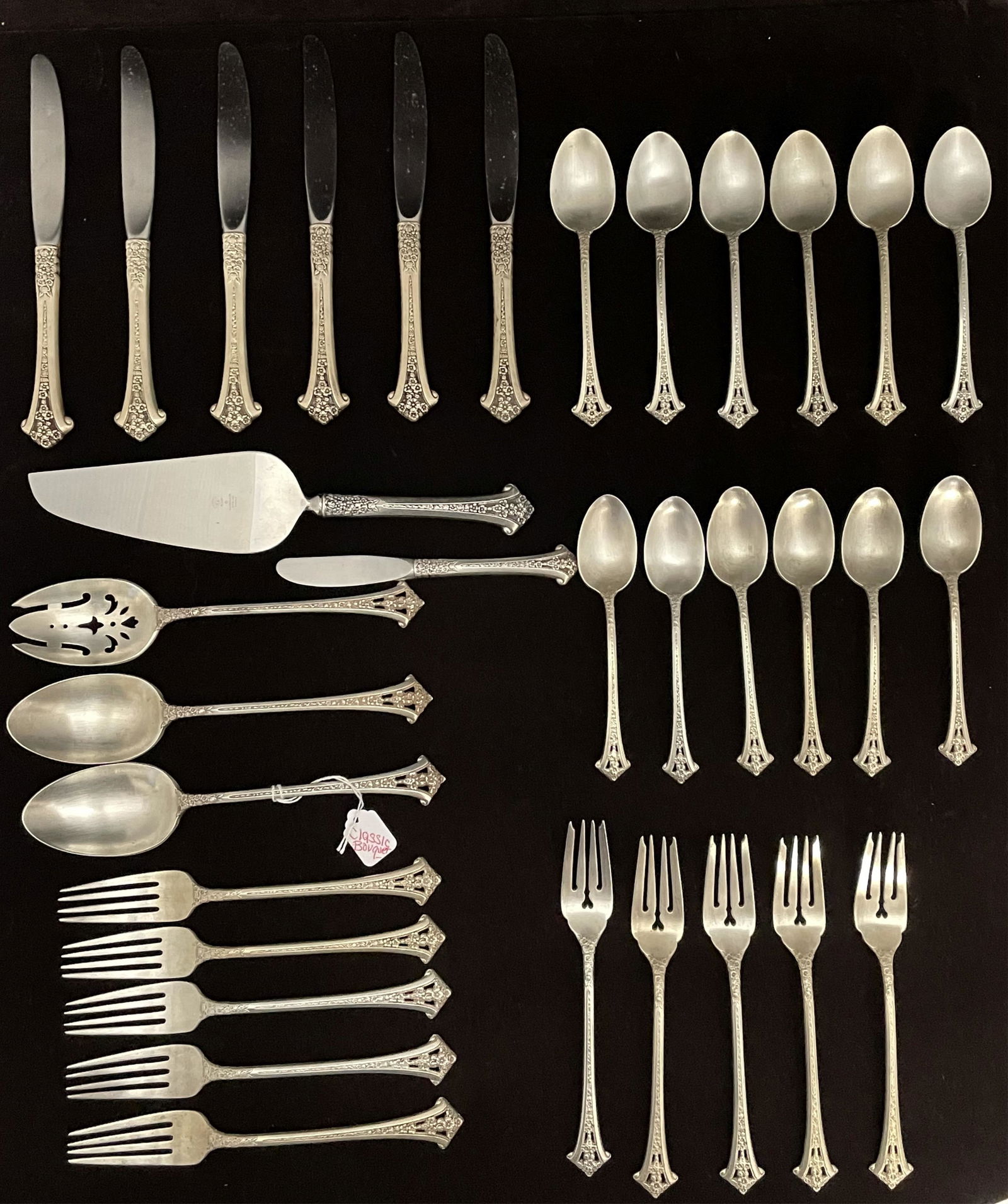 Sterling silver flatware set by Gorham, Classic: Bouquet pattern. To include: 6 dinner knives (9.25" long, weighted handles), 5 luncheon forks (7" long), 5 dinner forks (7 1/2" long), 2 table spoons (8 1/2" long), one serving spoon (8 1/2" long), 12