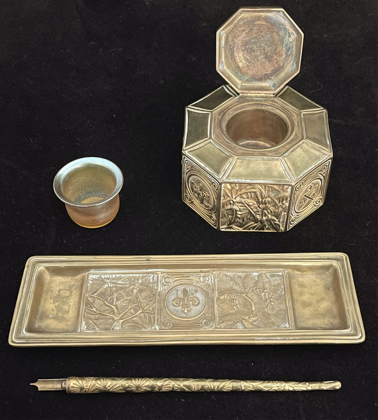 Two-piece Tiffany Studios bronze desk set in the: Bookmark pattern, along with unsigned and non-matching pen, possibly also by Tiffany. To include: an ink well with original favrile glass insert, signed L.centuryT. #7583, and stamped 864 on bottom, 4