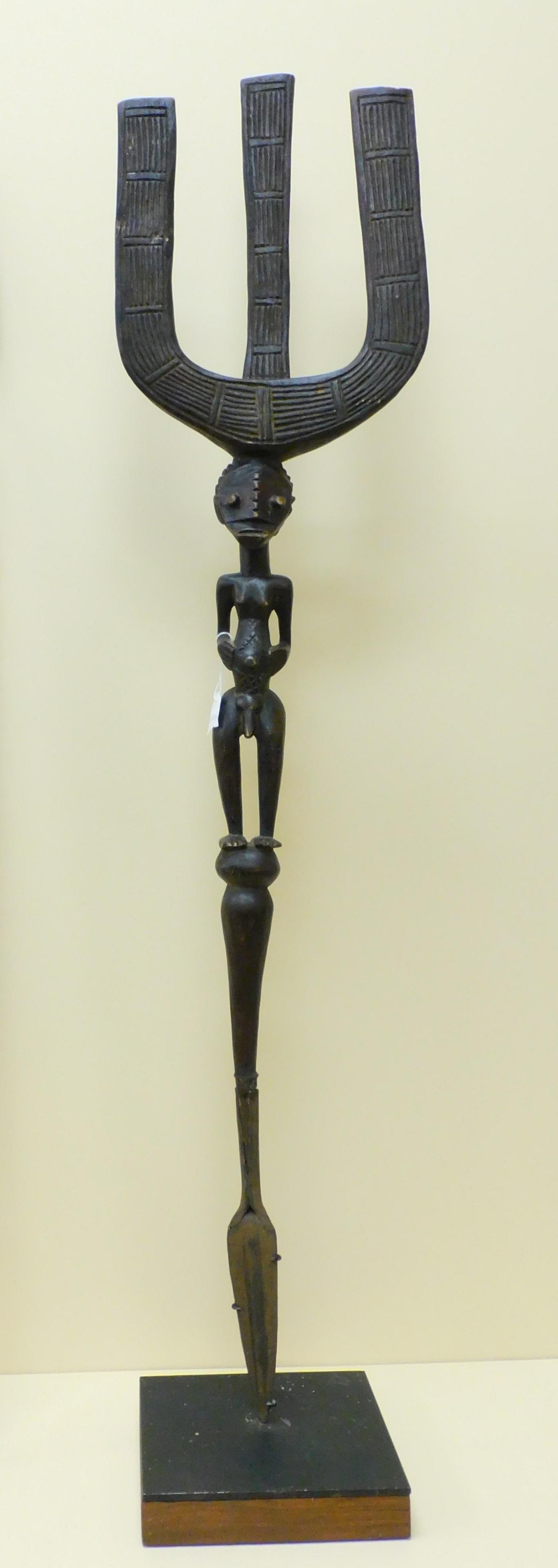 20th century African carved wooden and iron figural: spear, 52" high, 11" wide.