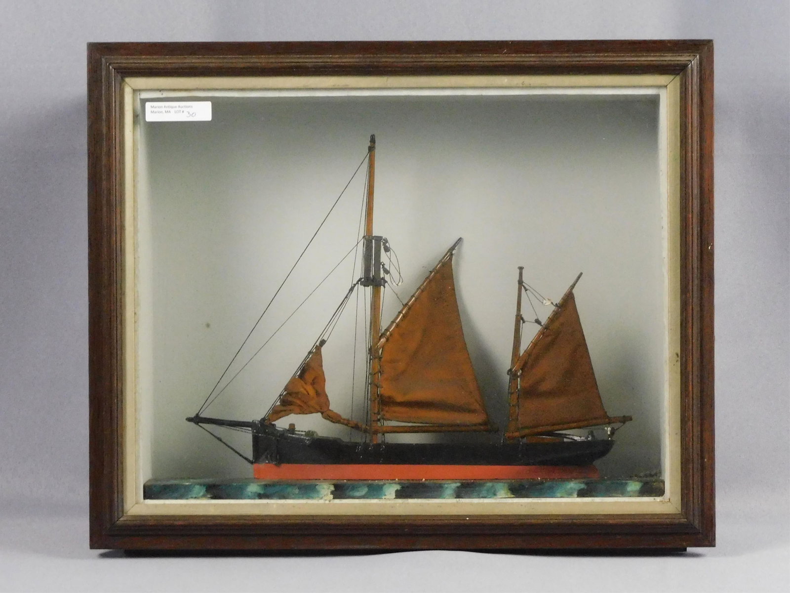 French Ship Diorama, ca. 1890. French fishing: sailboat in a shadow box frame. 11" x 13 3/4". Minor damage to mast rigging with plaster pieces cased inside frame. Provenance: Webb Estate.