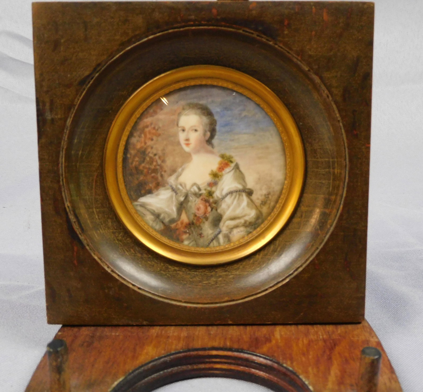 Miniature portrait of an elegantly dressed young: lady with flower garland, late 18th c. Round. Sight size 3" diameter, overall with frame 5" x 5 1/4". Provenance: Webb estate.