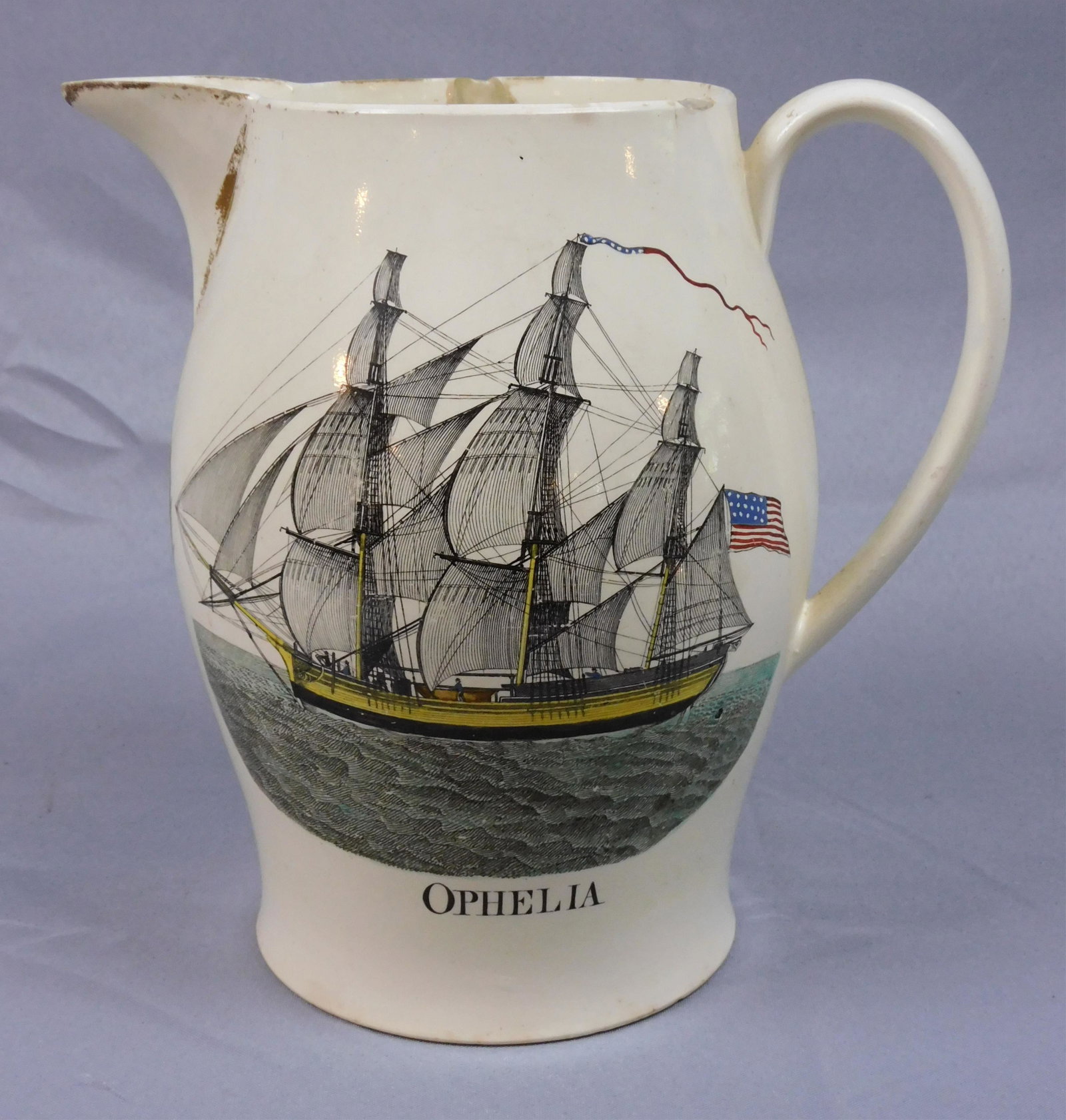 Liverpool jug depicting the ship Ophelia and: Masonic symbols, early 19th c. Wreath with initials. Polychrome paint decorated, flying the American flag. Shows chips to rim and underside of base. 10 1/2" tall.