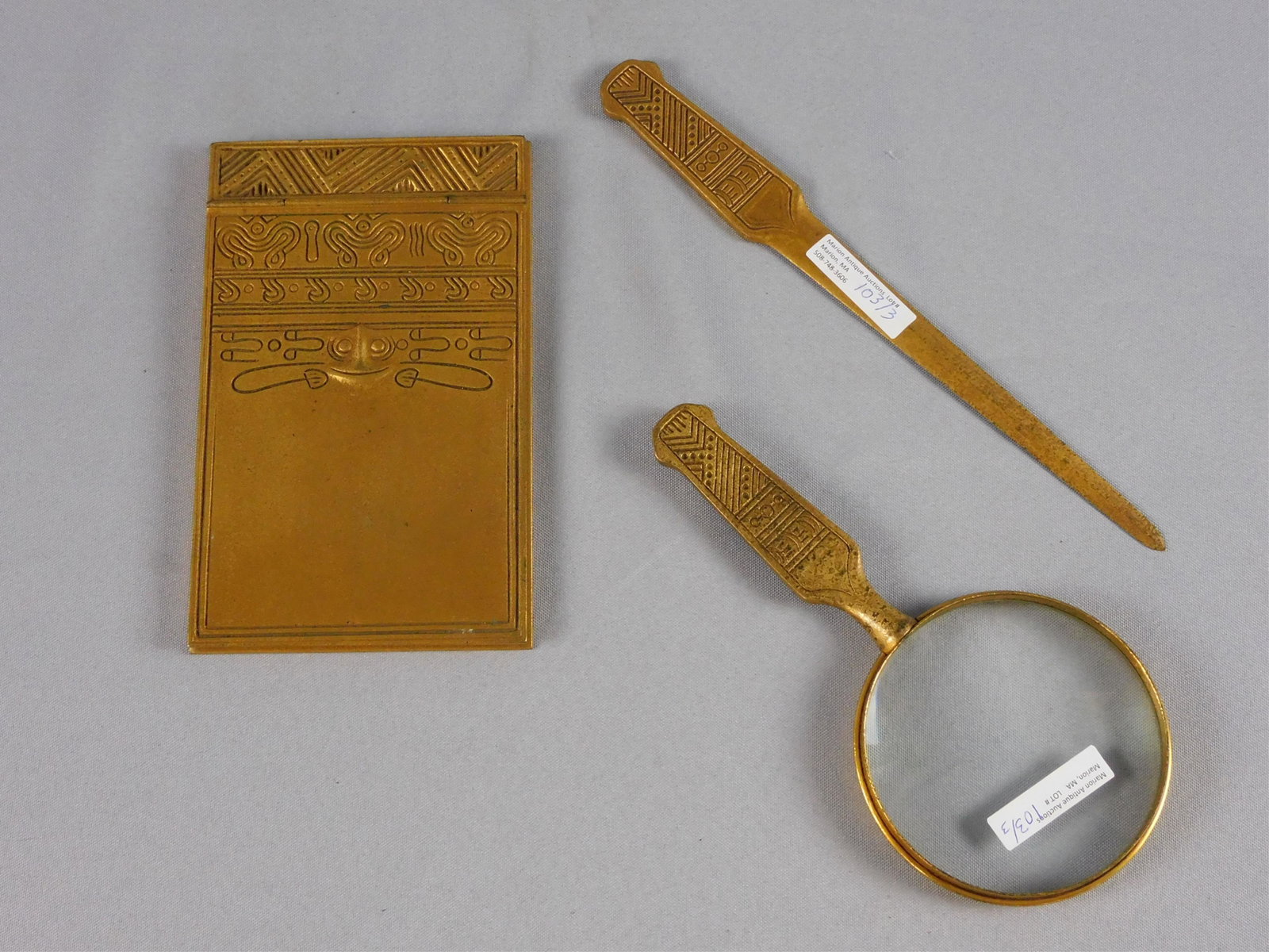 Tiffany Studios 3-piece desk set, American Indian: pattern, ca. 1900. Gilded bronze. To include: letter opener (10 1/2" long, signed Tiffany Studios NY 1189), a heavy notepad holder with original gilded edged paper insert (7 1/2" x 5", signed Tiffany 