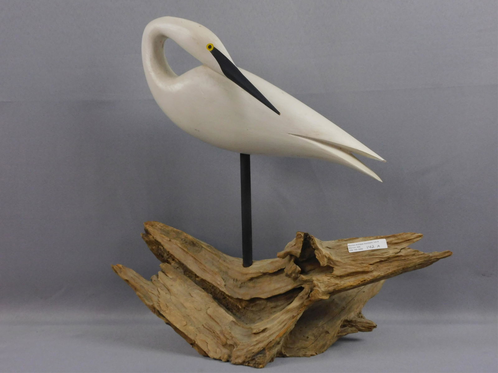 Snowy Egret decoy, stamped Jamie P Hand (Cape: May, Courthouse, NJ). Mounted on a driftwood base. Late 20th c. hand carved and painted wood. The decoy itself is 15" long, 5 1/2" high. With base, 16 1/2" high, 16" wide.