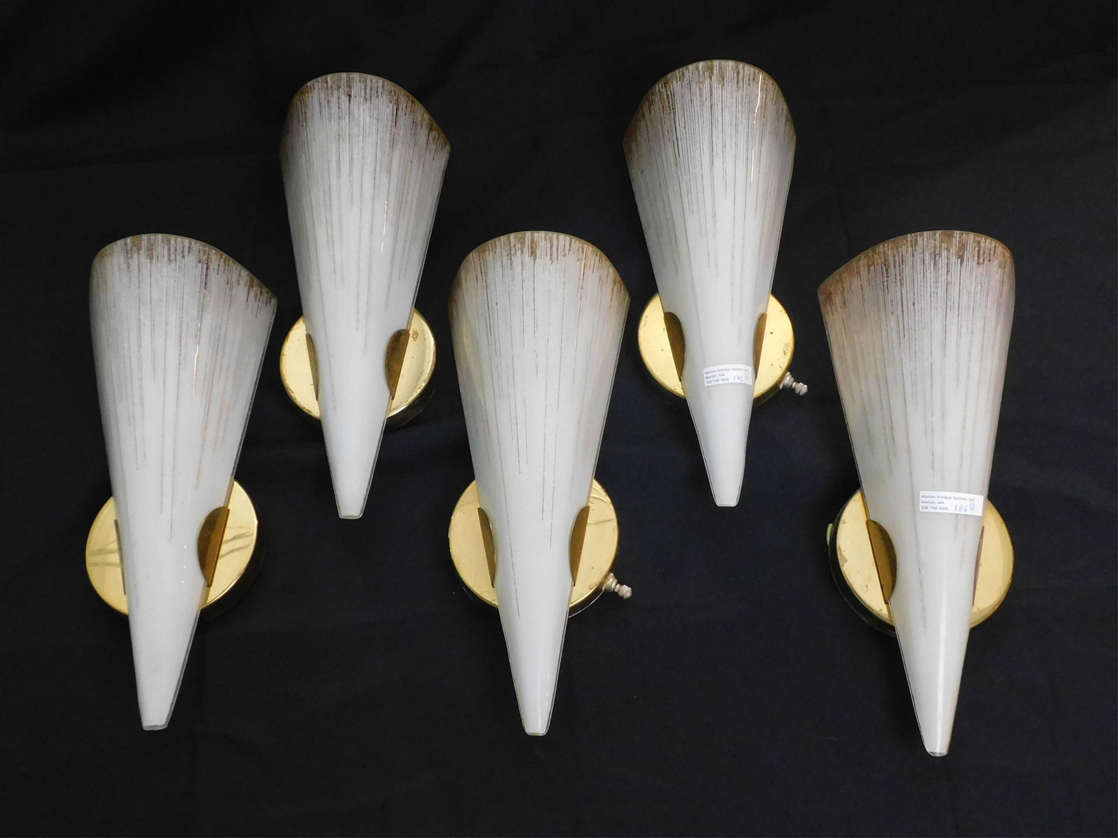 Lightolier brass and glass wall sconces, set of: five. Ca. 1950s. Tiny beads of colored glass. Lightolier Claremont Glass, produces sparkling light. 13" high, 5 1/2" wide, 3 1/2" diameter. Two have individual switches. Some tarnish to the brass. Gla