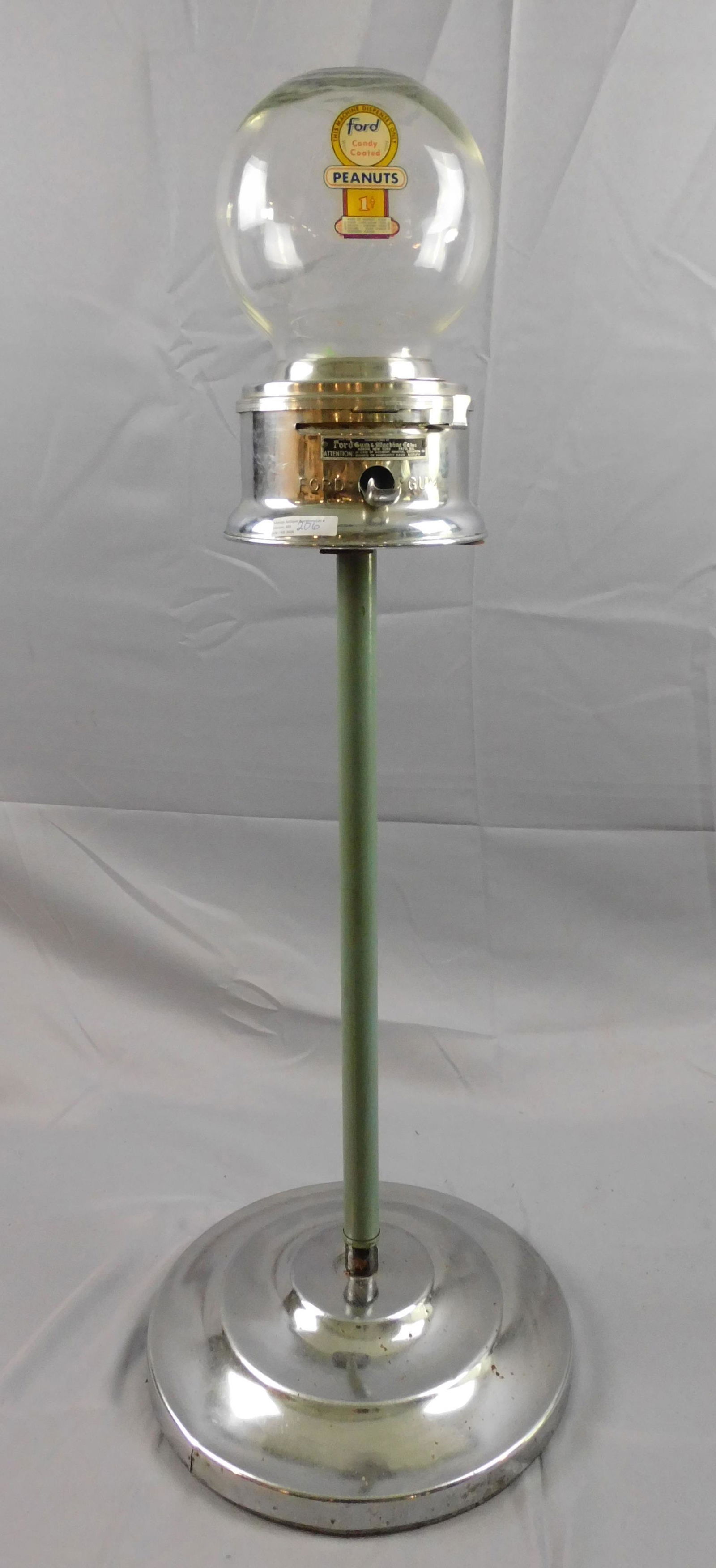 Vintage Ford standing peanut / gumball machine.: Original decal. 1 cent machine, Ford Gum. Round glass container, chrome mechanism and base with a painted shaft. 37 1/2" high, glass ball approximately 7 1/2" diameter, 14" base diameter. Good overall