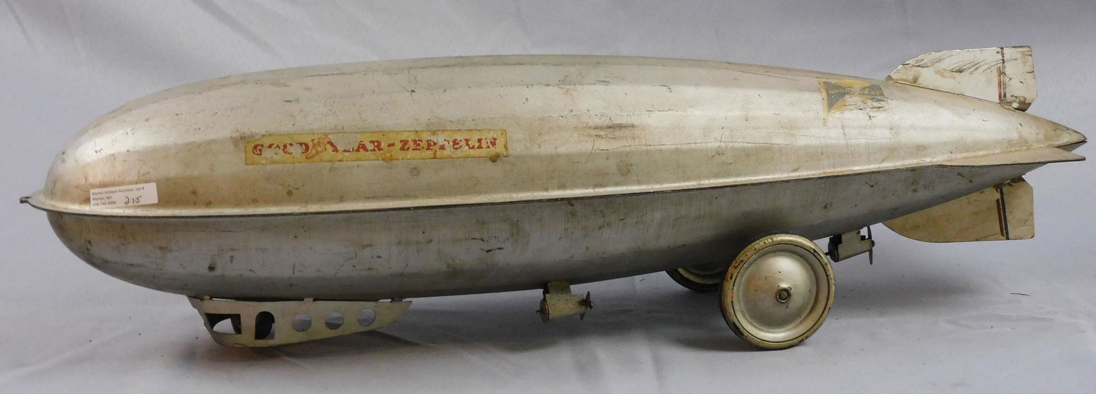 Goodyear Graf Zeppelin pull toy, early 20th c.: Pressed steel. 30" long, 8" wide, 8" high. Shows age appropriate wear from use. Decal is present.