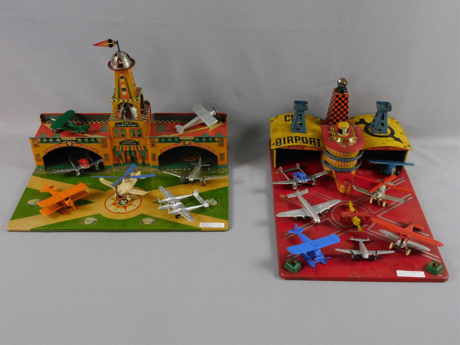 Wyandotte tin litho City Airport, ca. 1930s.: Includes 7 Tootsietoy planes. 11" high, 16" wide, 11" deep. Overall good original condition. Along with a Marx City Airport, ca. 1930s. Includes 8 Tootsietoys planes. 7" high, 11" wide, 17" deep. Miss