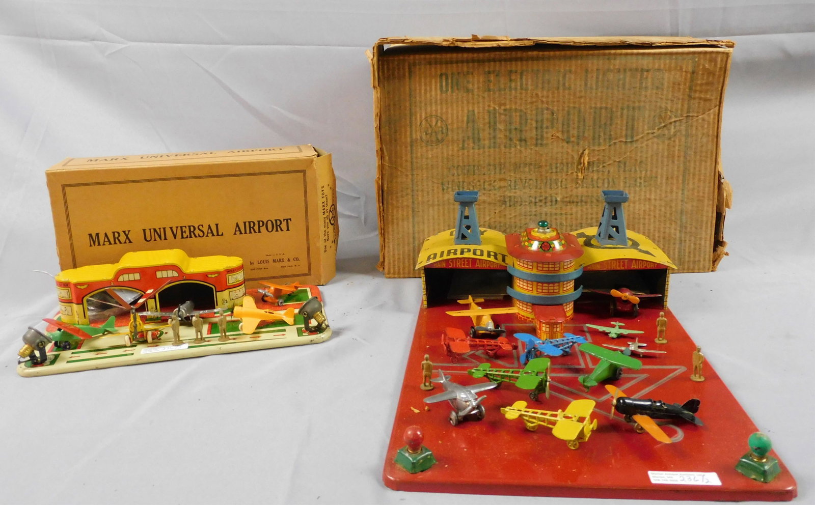 Marx Universal airport tin litho toy with: original box, ca. 1930s, with 5 airplanes by Tootsietoys and others. 3" high, 12" wide, 6 1/2" deep. The flying gyro airplane comes with an original box. Along with 3 Tootsietoy group crew figures. Al