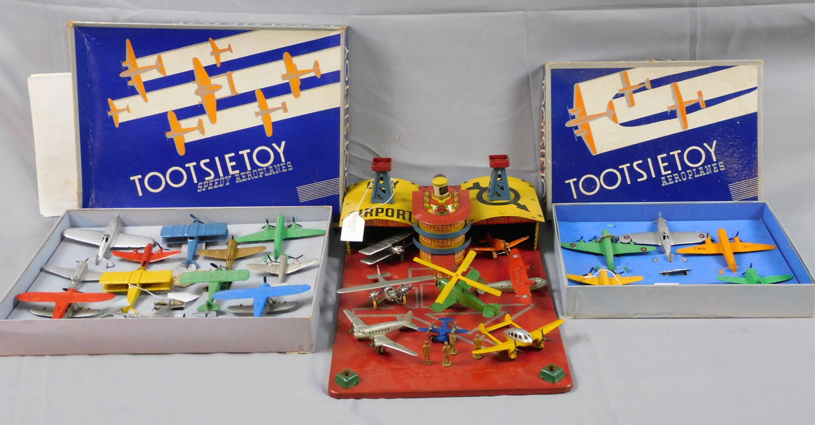 Marx tin litho city airport, Main Street Airport.: Comes with 6 Tootsietoy airplanes, and 2 unmarked. 4 figures. 11" wide, 17" deep, 6 1/2" high. Missing two bulbs, shows age appropriate wear, overall good condition. Along with Tootsietoy aeroplanes i